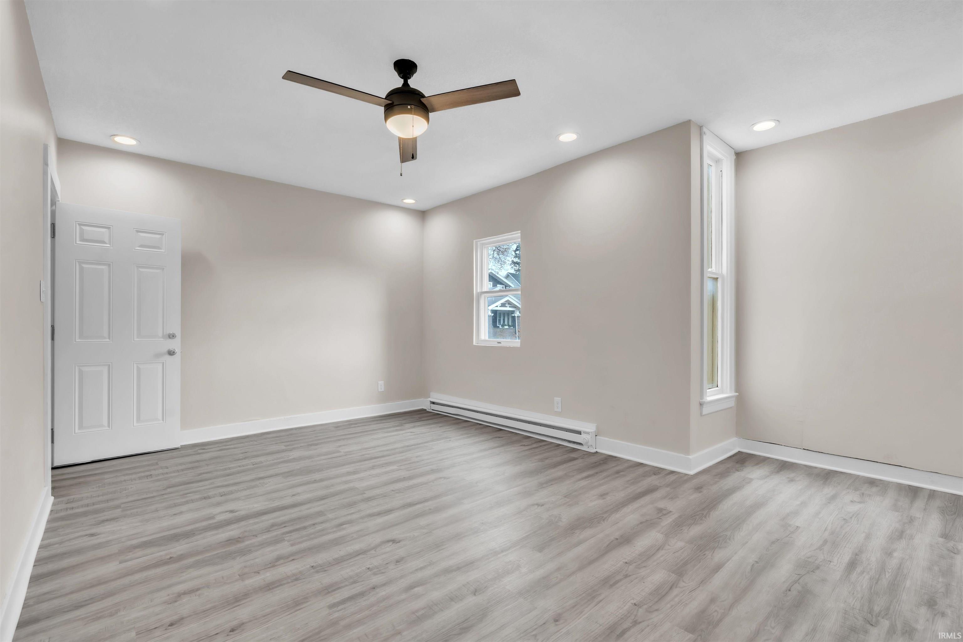 Unfurnished room with baseboard heating, recessed lighting, light wood-style floors, and ceiling fan