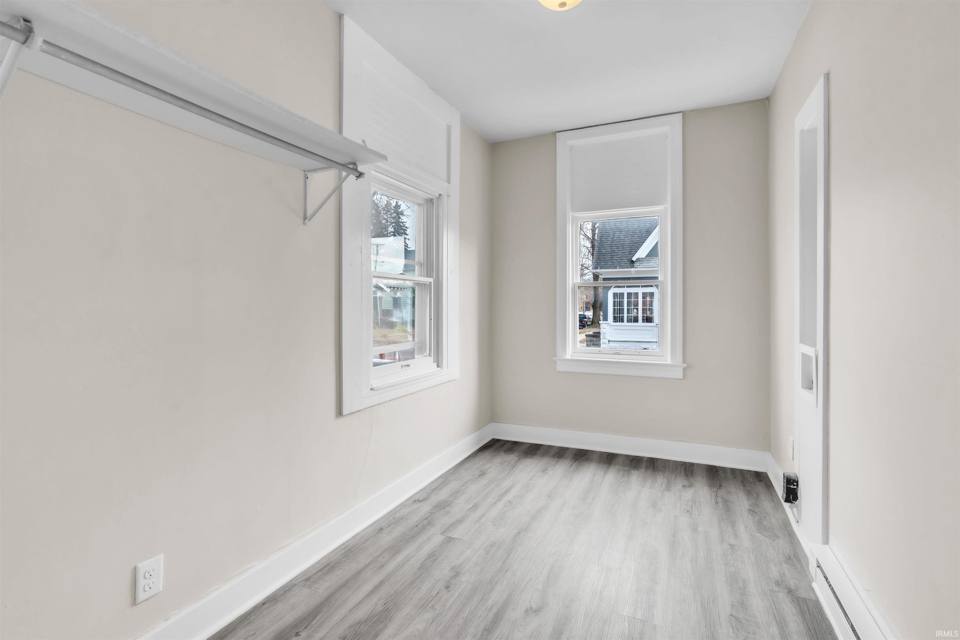 Spare room featuring baseboards and light wood-style flooring