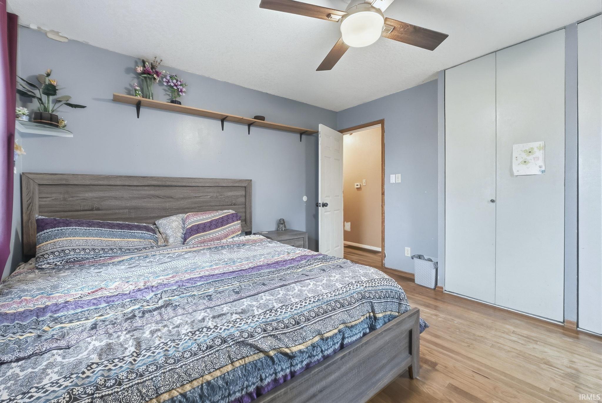 Bedroom featuring wood finished floors and a ceiling fan