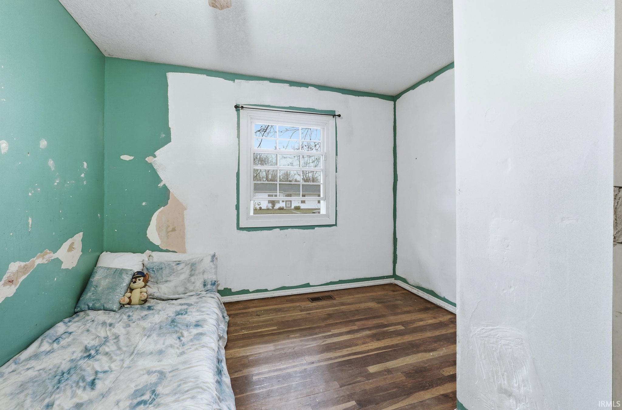 Bedroom featuring dark wood-type flooring