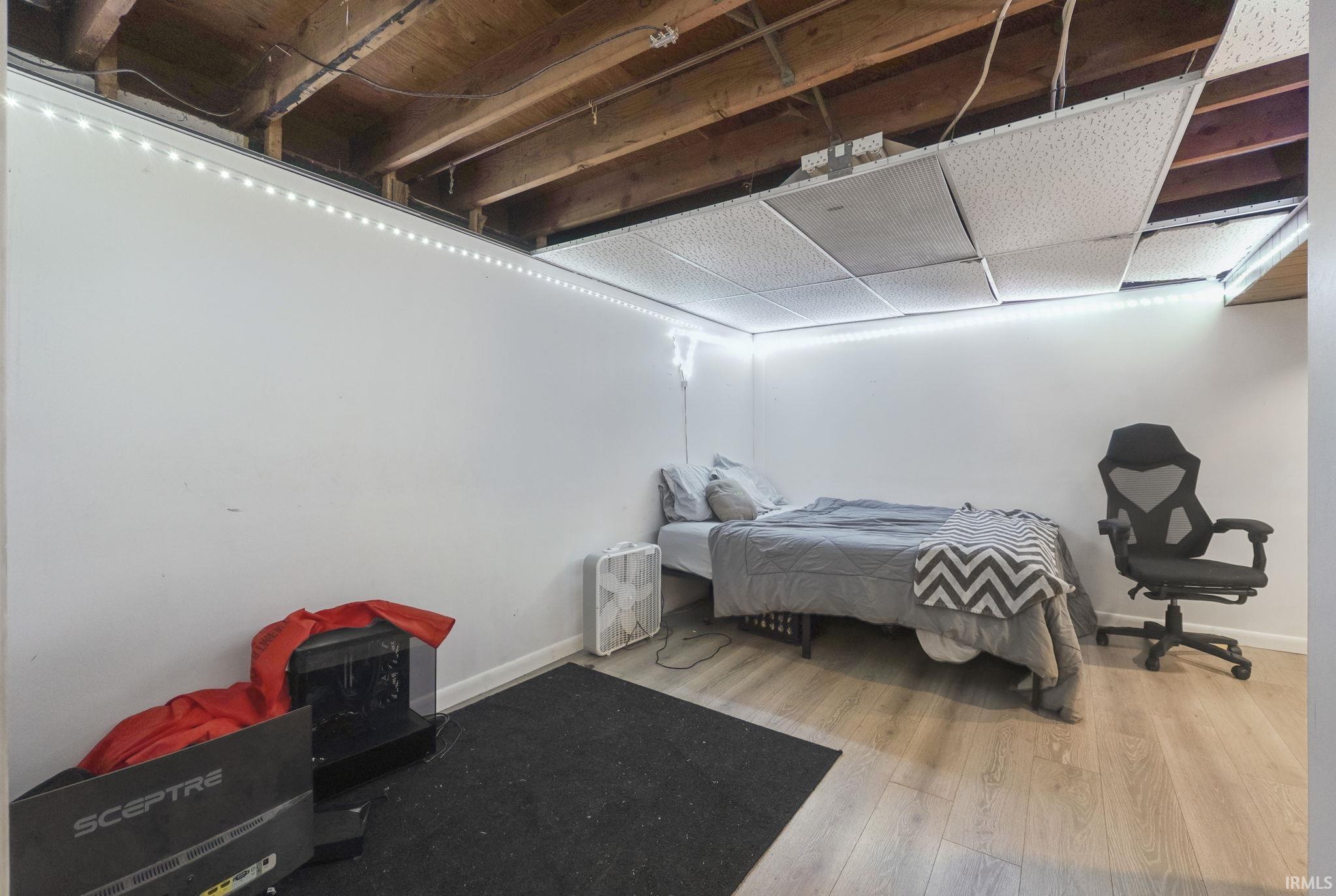 Bedroom with wood finished floors and baseboards