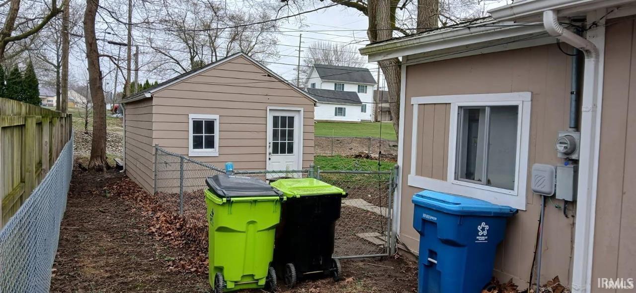 View of side of home with an outdoor structure