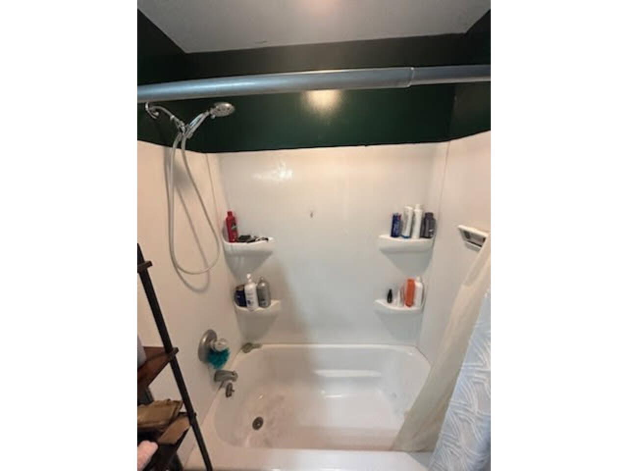 Full bathroom featuring shower / bath combination with curtain