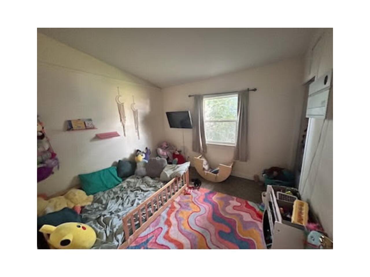 Bedroom featuring lofted ceiling