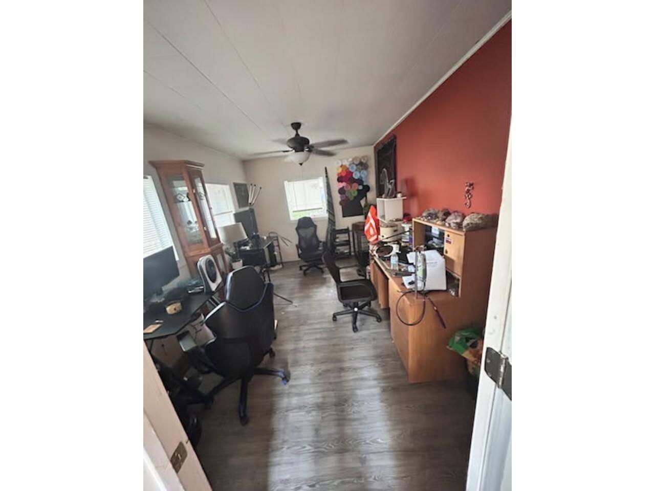 Office space featuring dark wood finished floors and ceiling fan