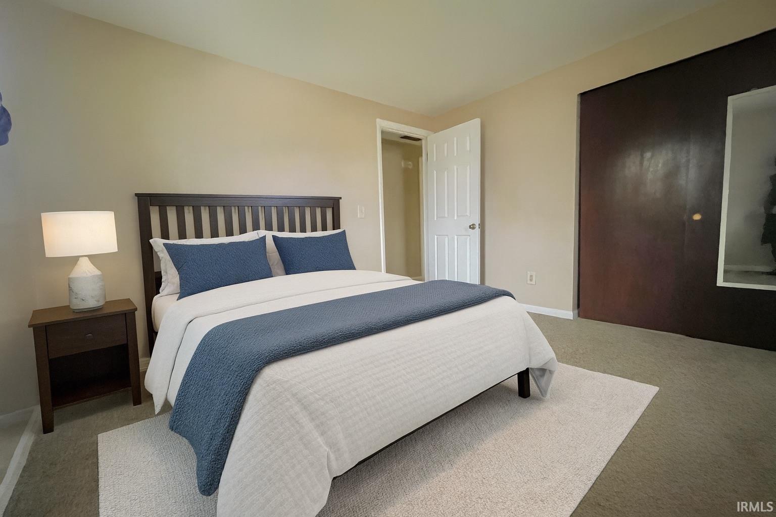 Bedroom with light colored carpet