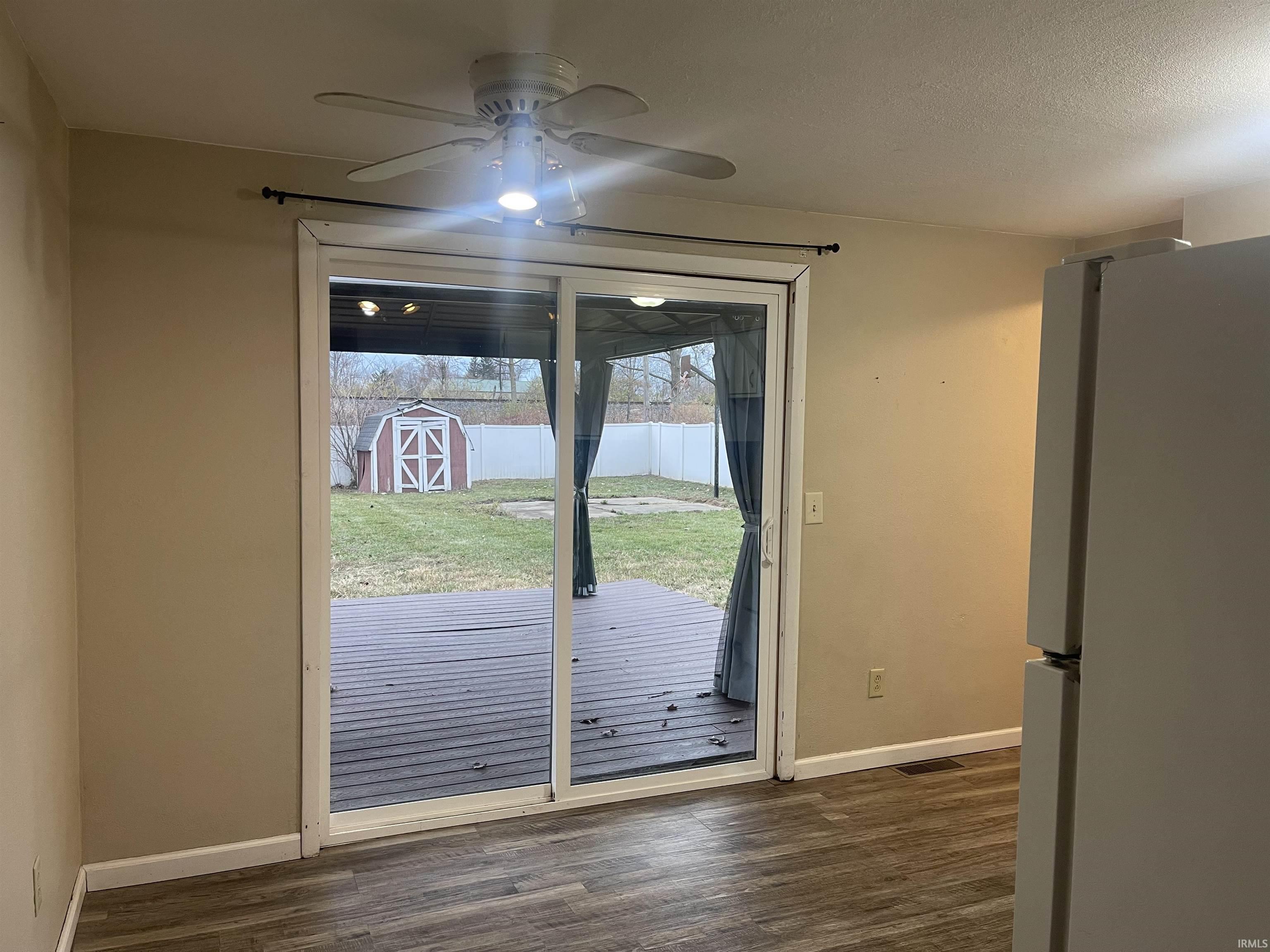 Doorway featuring wood finished floors and ceiling fan