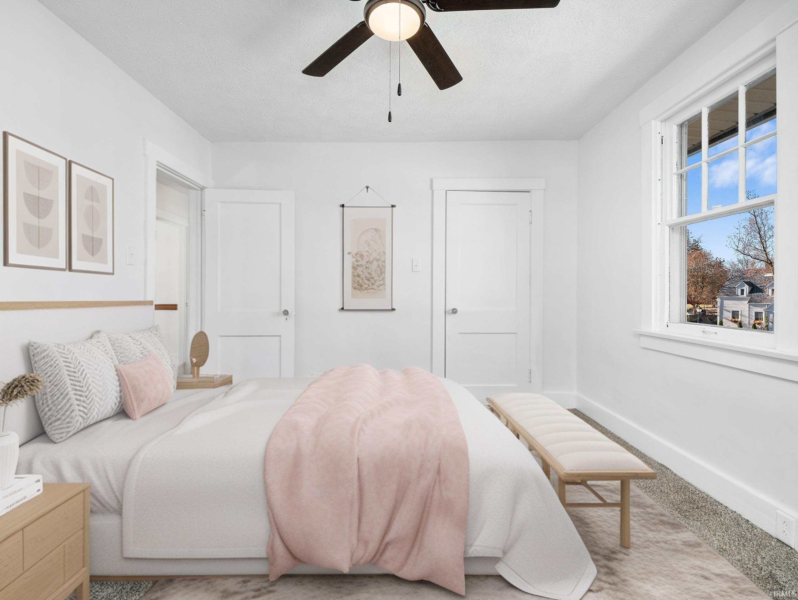 Bedroom with ceiling fan and baseboards