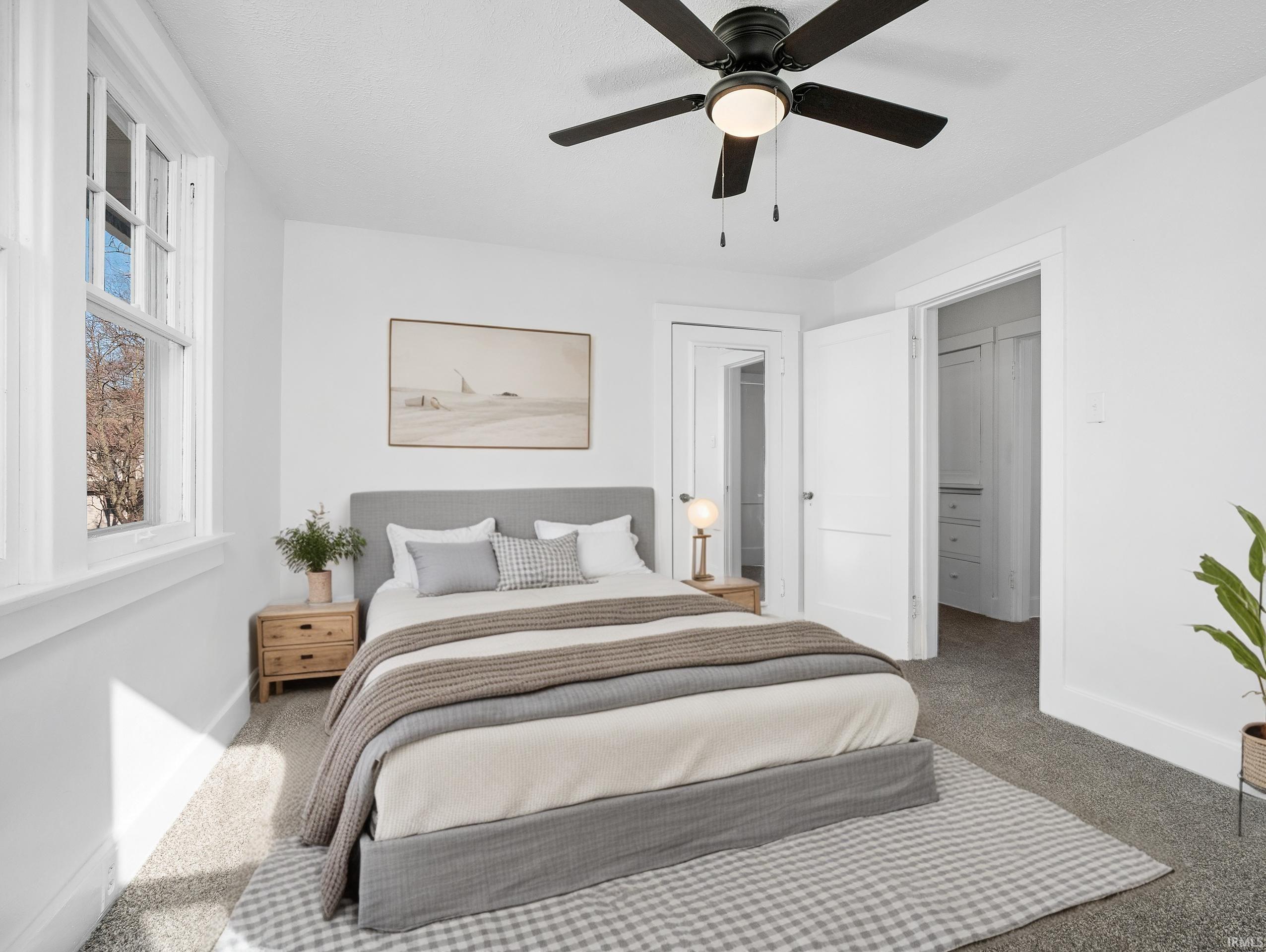 Bedroom with carpet and a ceiling fan