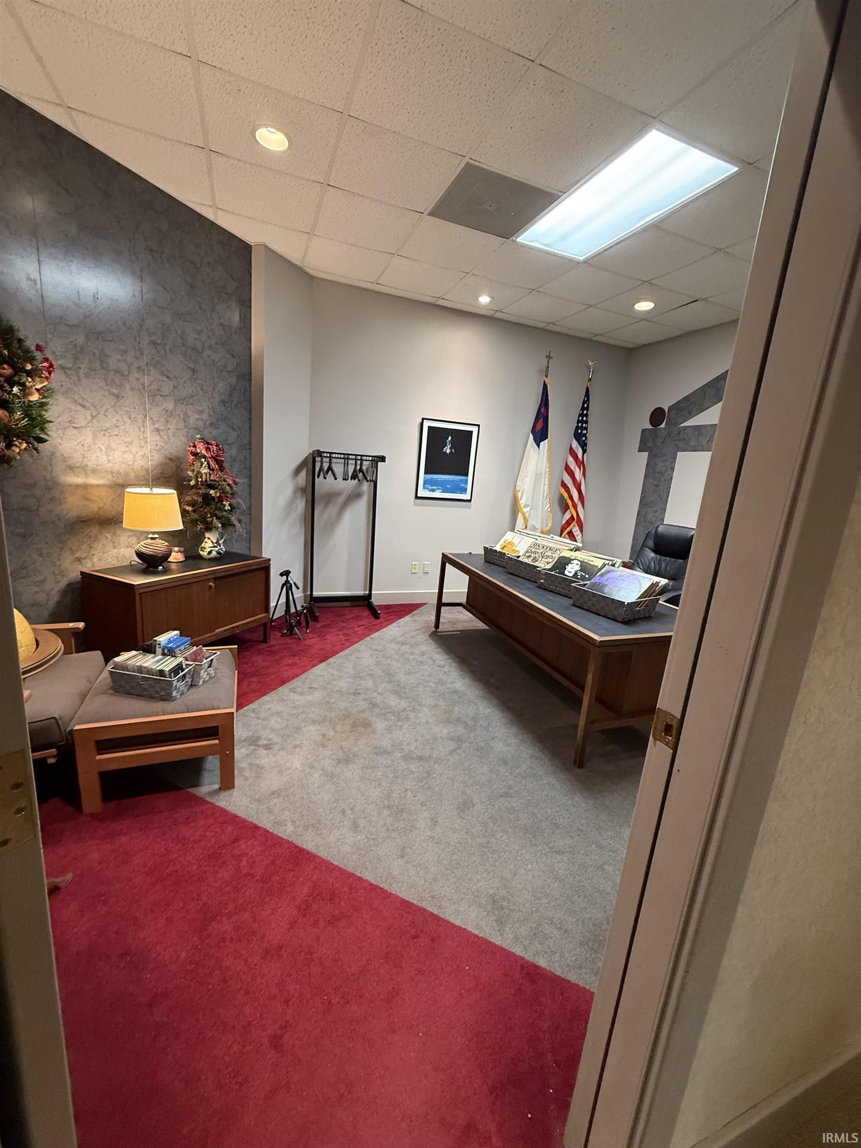 Carpeted bedroom with an accent wall, a drop ceiling, and recessed lighting