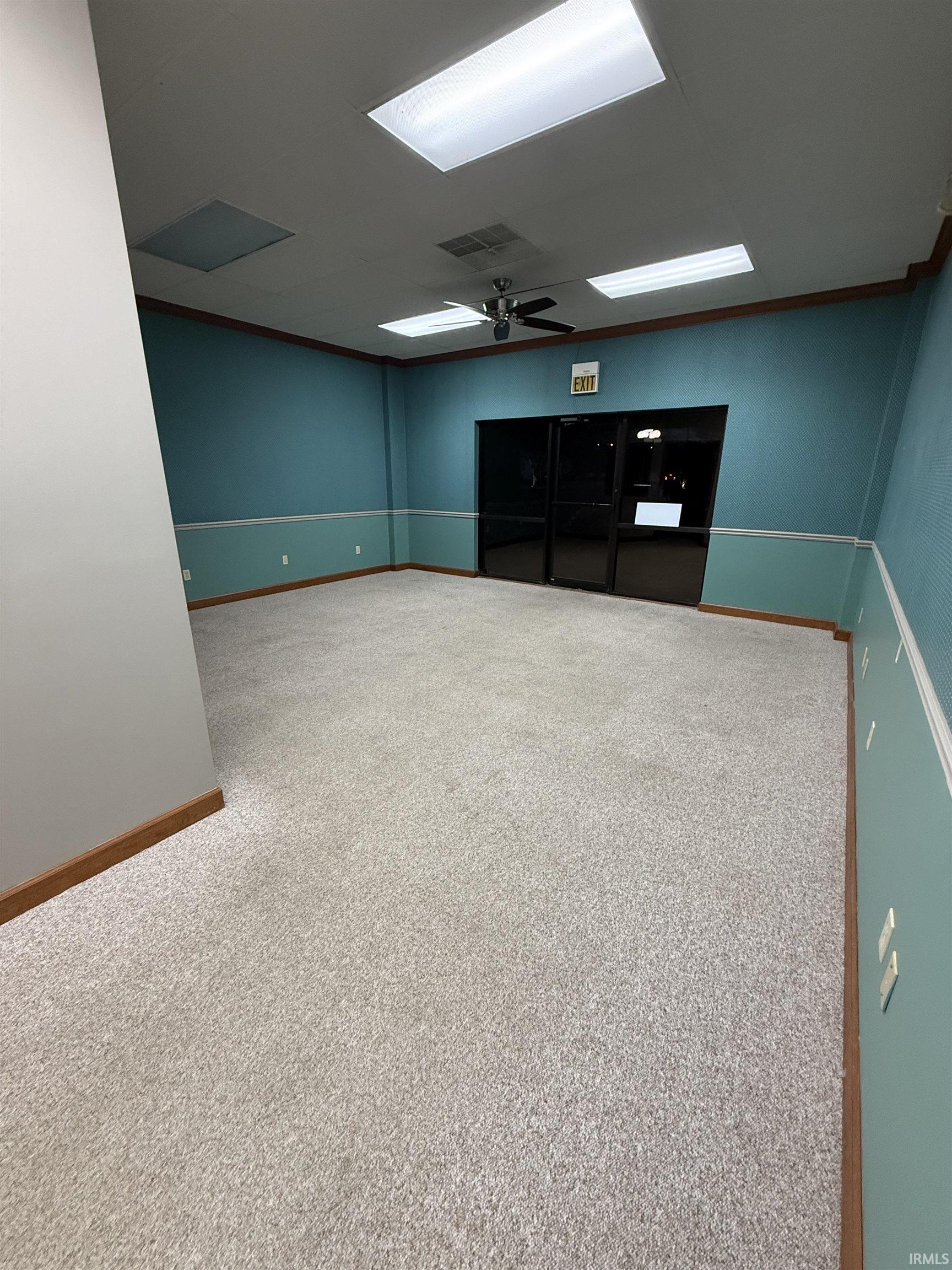 Unfurnished room with ceiling fan and carpet floors