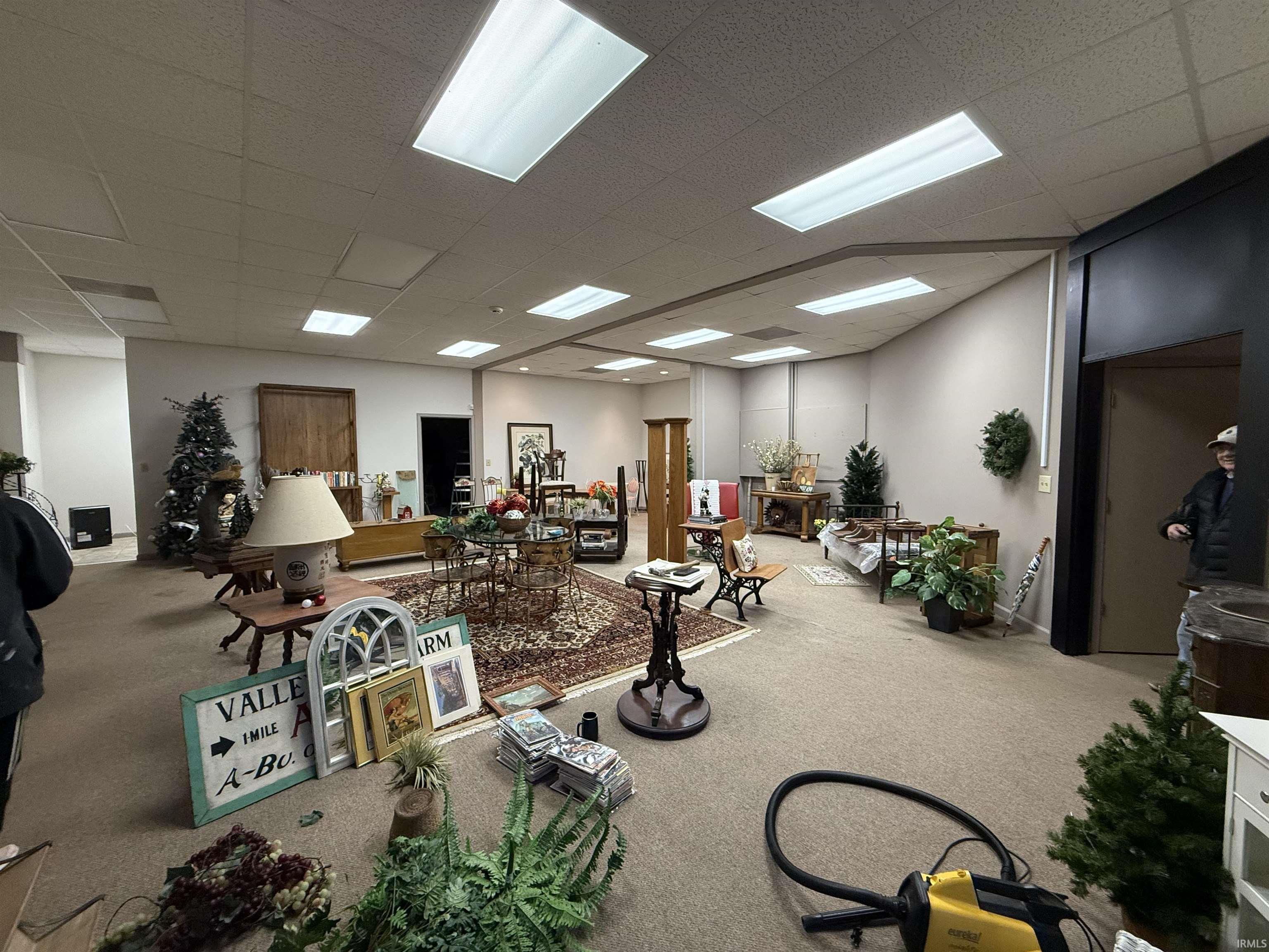 Miscellaneous room featuring carpet flooring and a drop ceiling