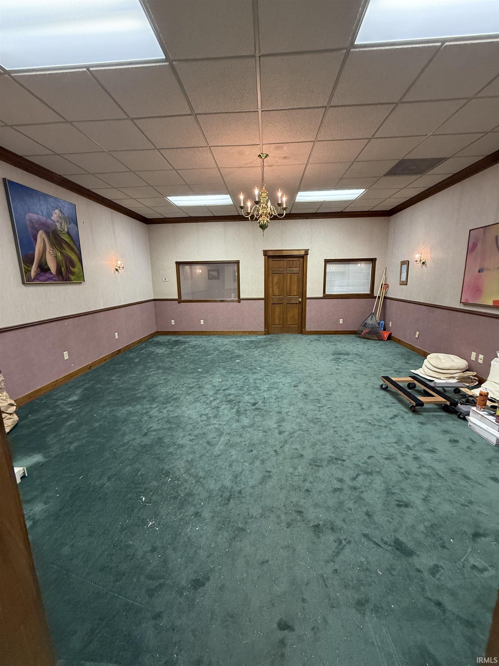 Workout room featuring a drop ceiling and carpet