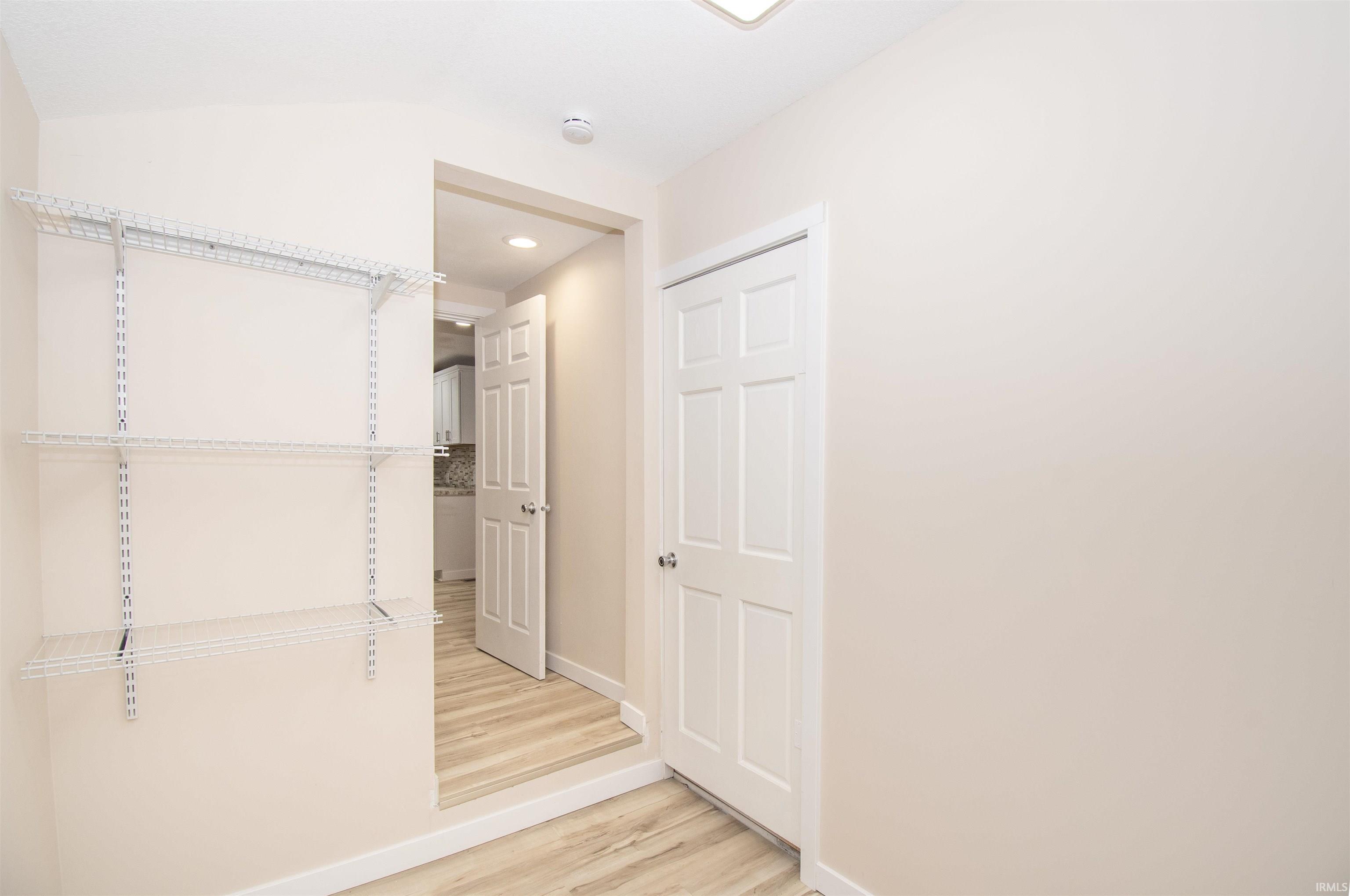 Walk in closet featuring light wood finished floors