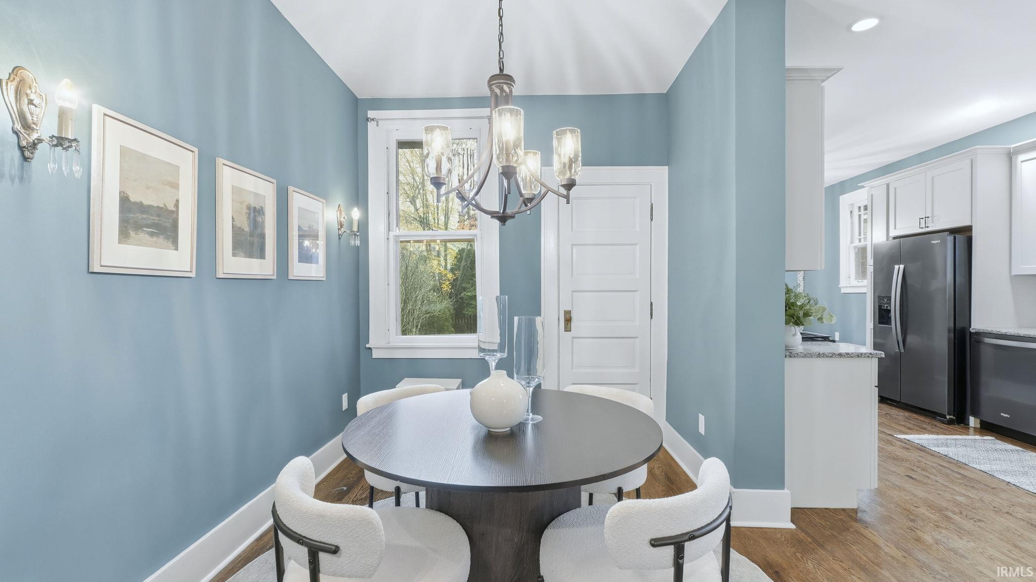 Dining space featuring light wood-style flooring, a chandelier, and recessed lighting