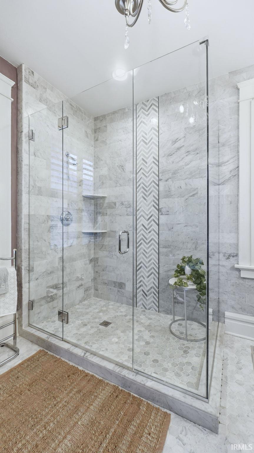 Full bathroom featuring a marble finish shower