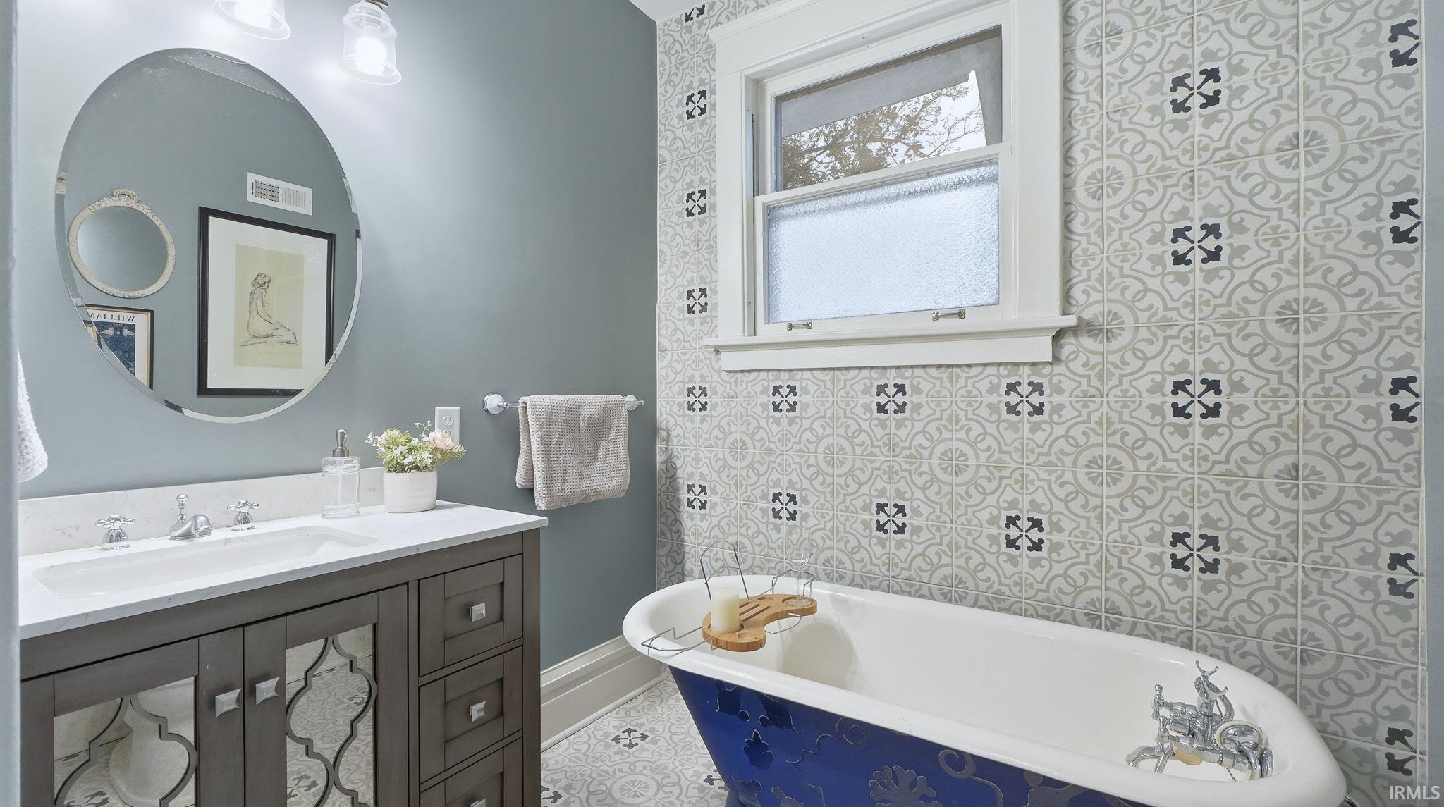 Bathroom with a soaking tub and vanity