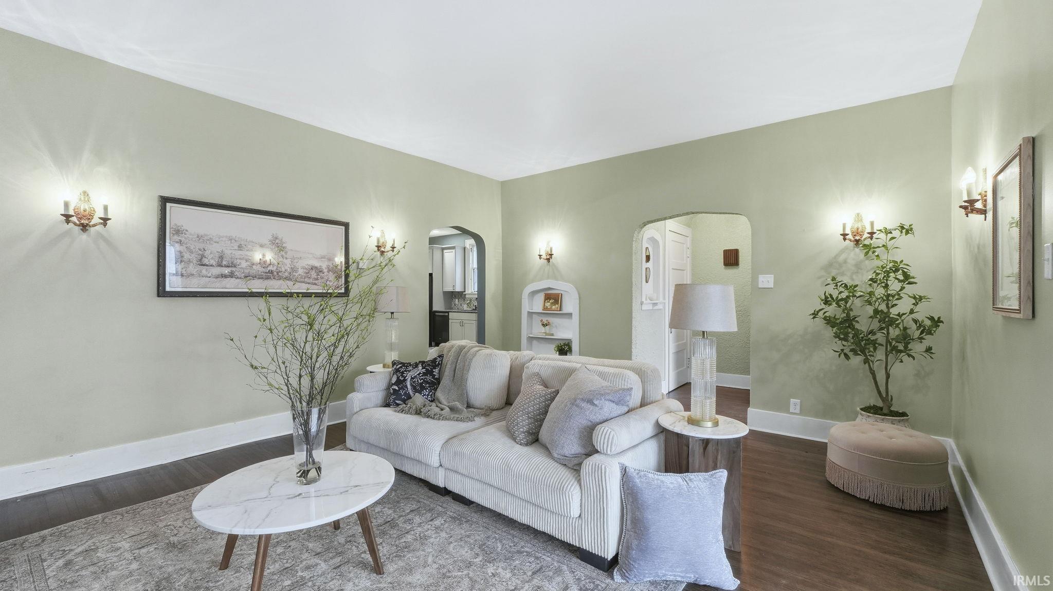 Living room featuring wood finished floors and arched walkways