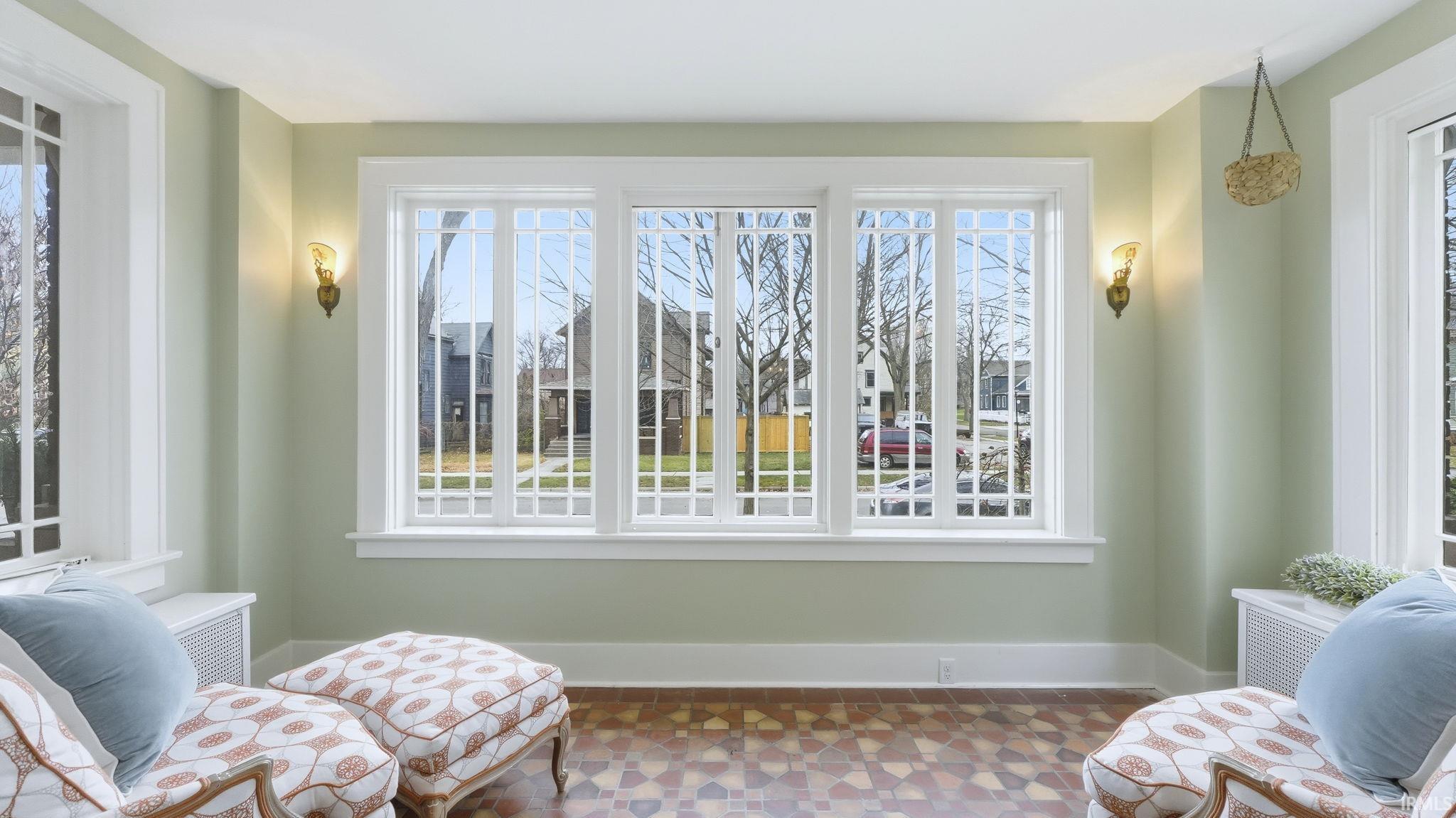 Living area featuring tile patterned floors and plenty of natural light