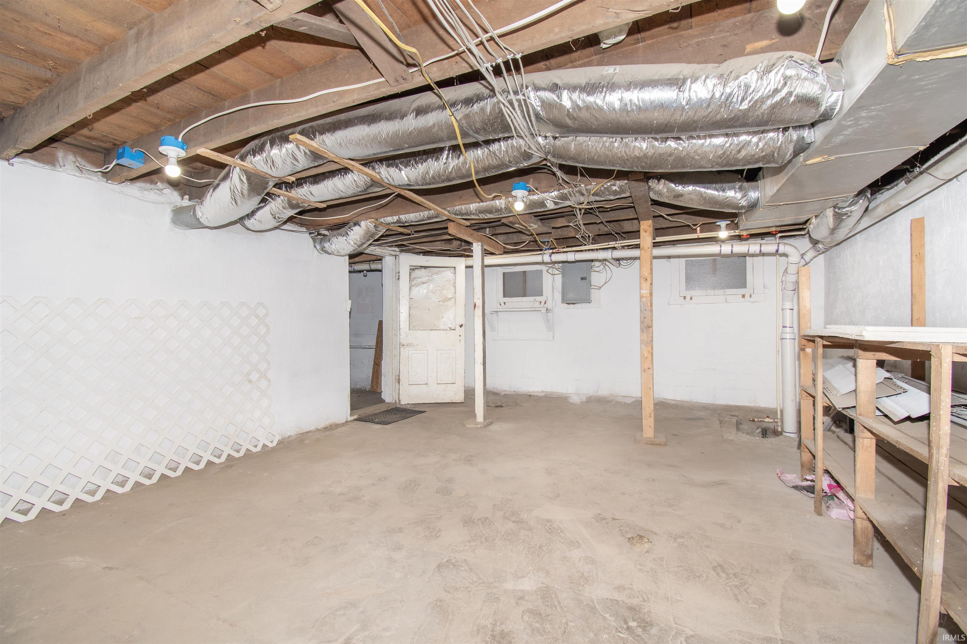 Unfinished basement featuring electric panel