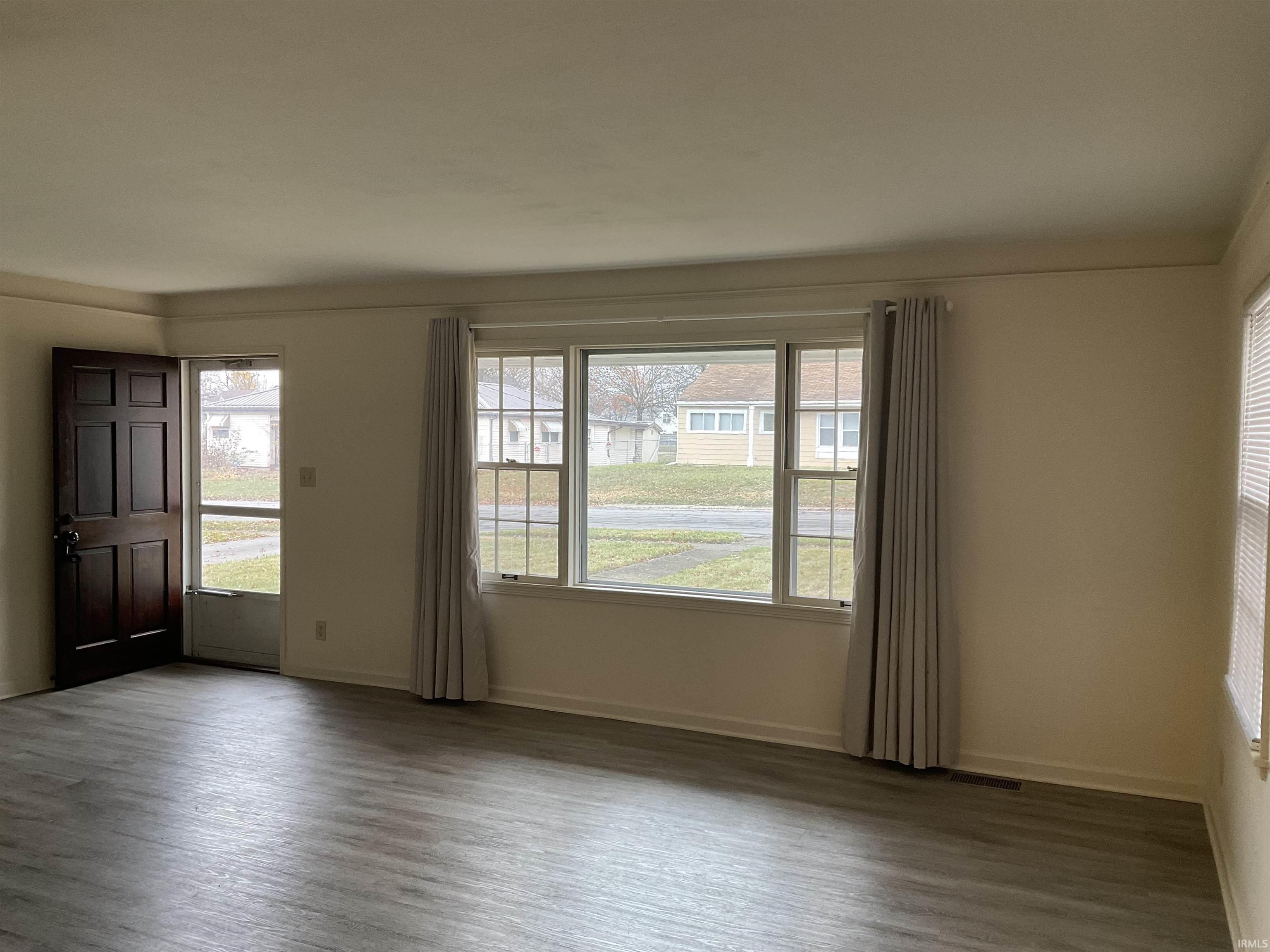 Spare room featuring wood finished floors