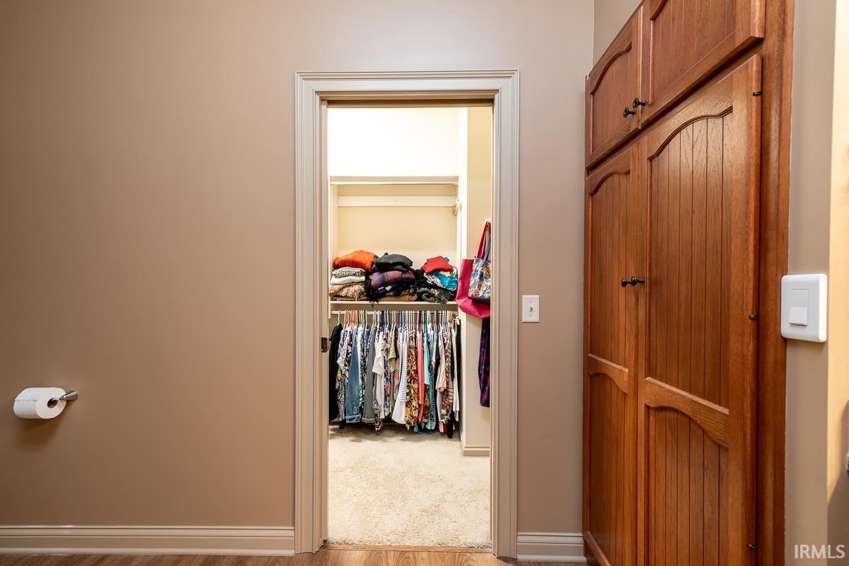 Spacious closet with light wood-style flooring
