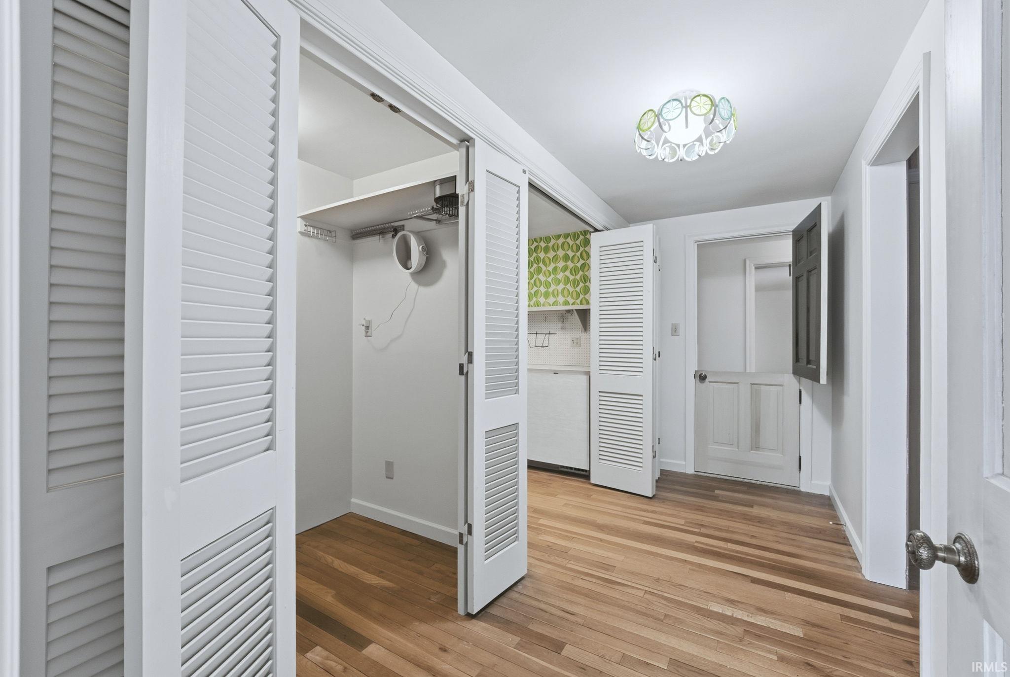 Hall featuring light wood-style floors