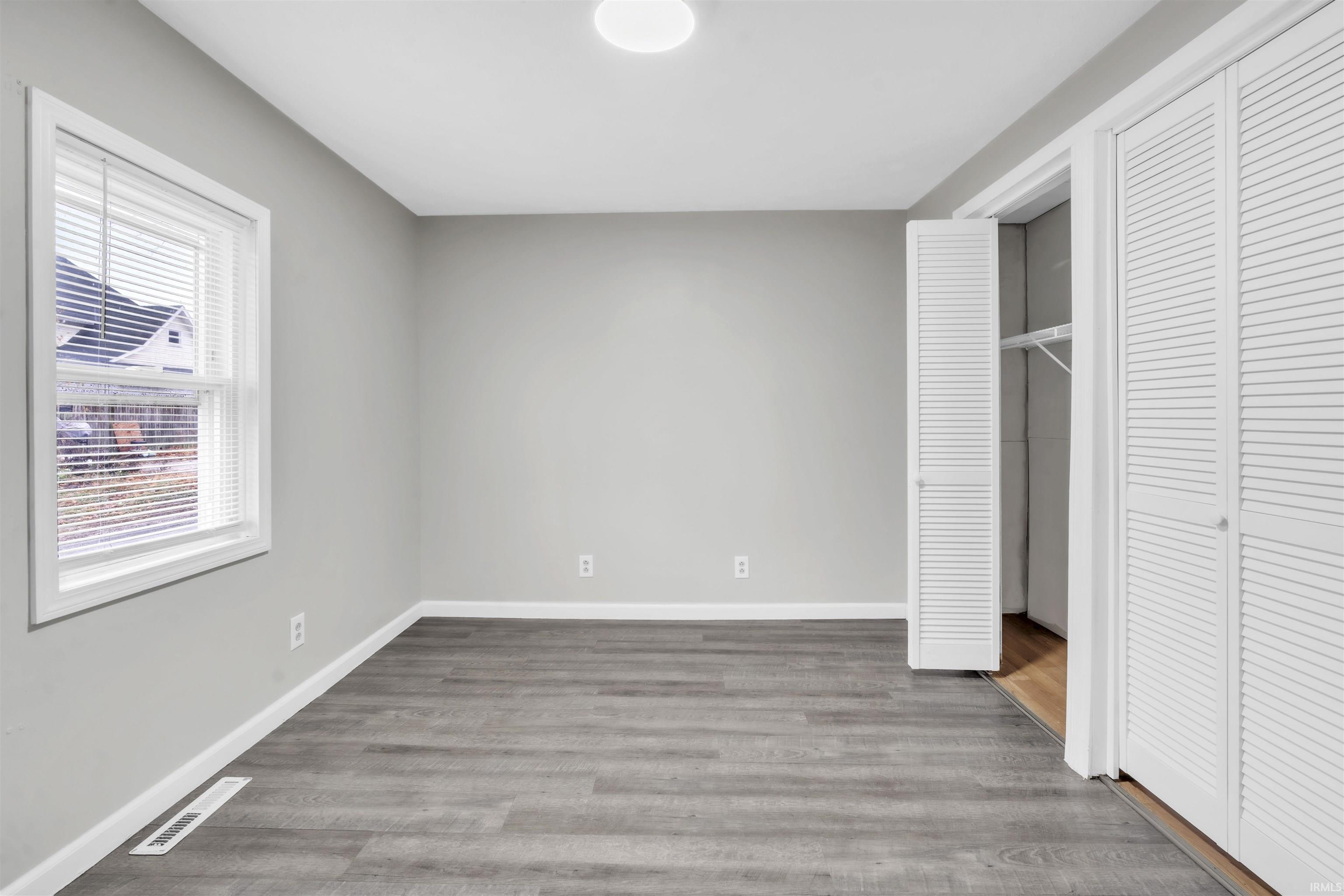 Unfurnished bedroom with a closet and light wood-type flooring