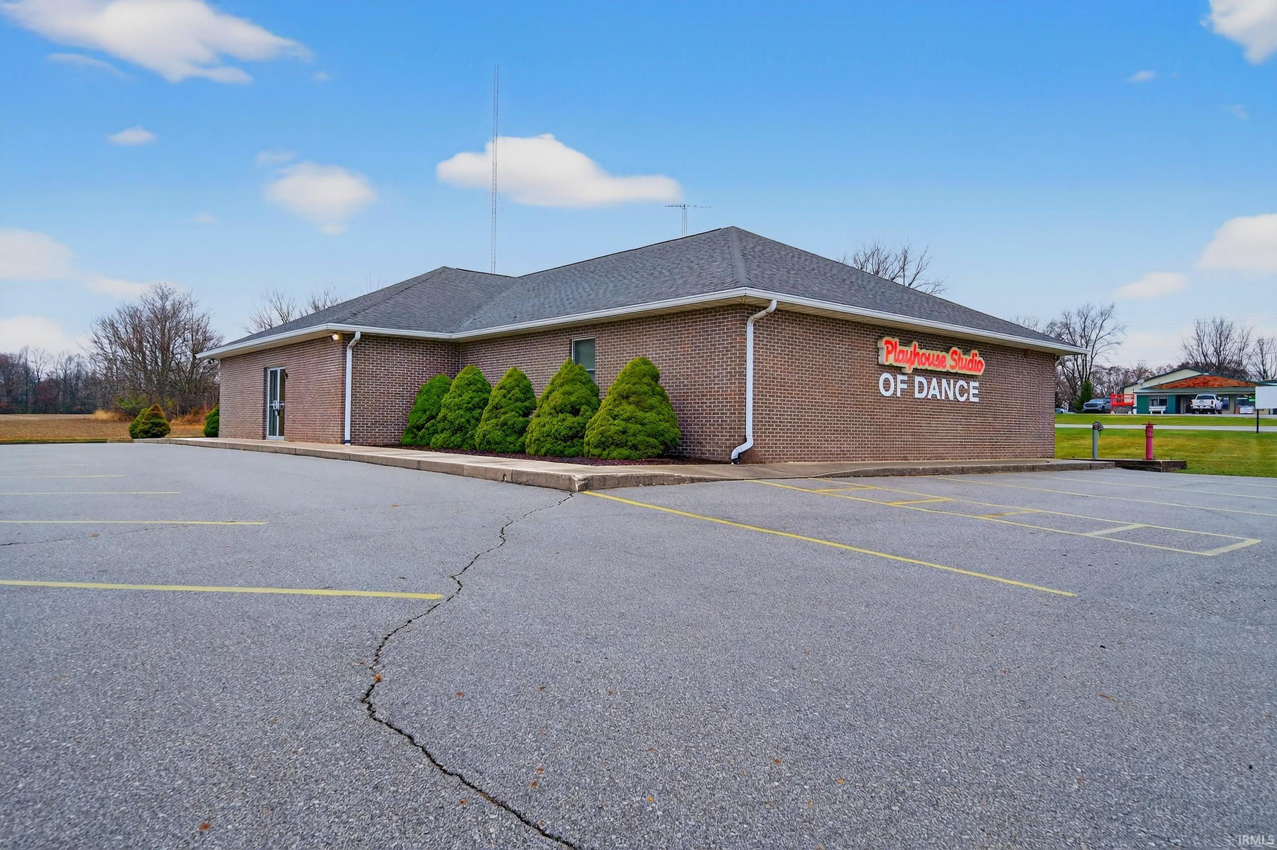View of property with uncovered parking