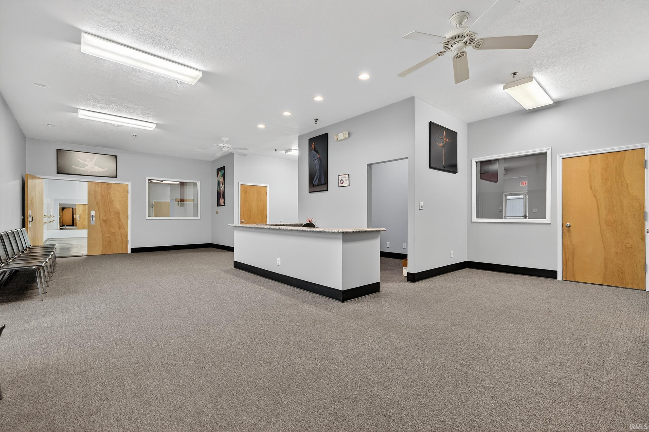 Reception featuring a ceiling fan, recessed lighting, and a textured ceiling