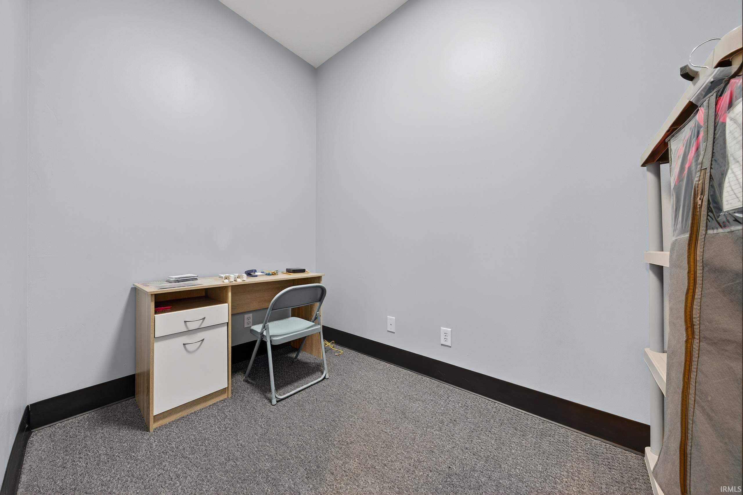 Carpeted office with baseboards