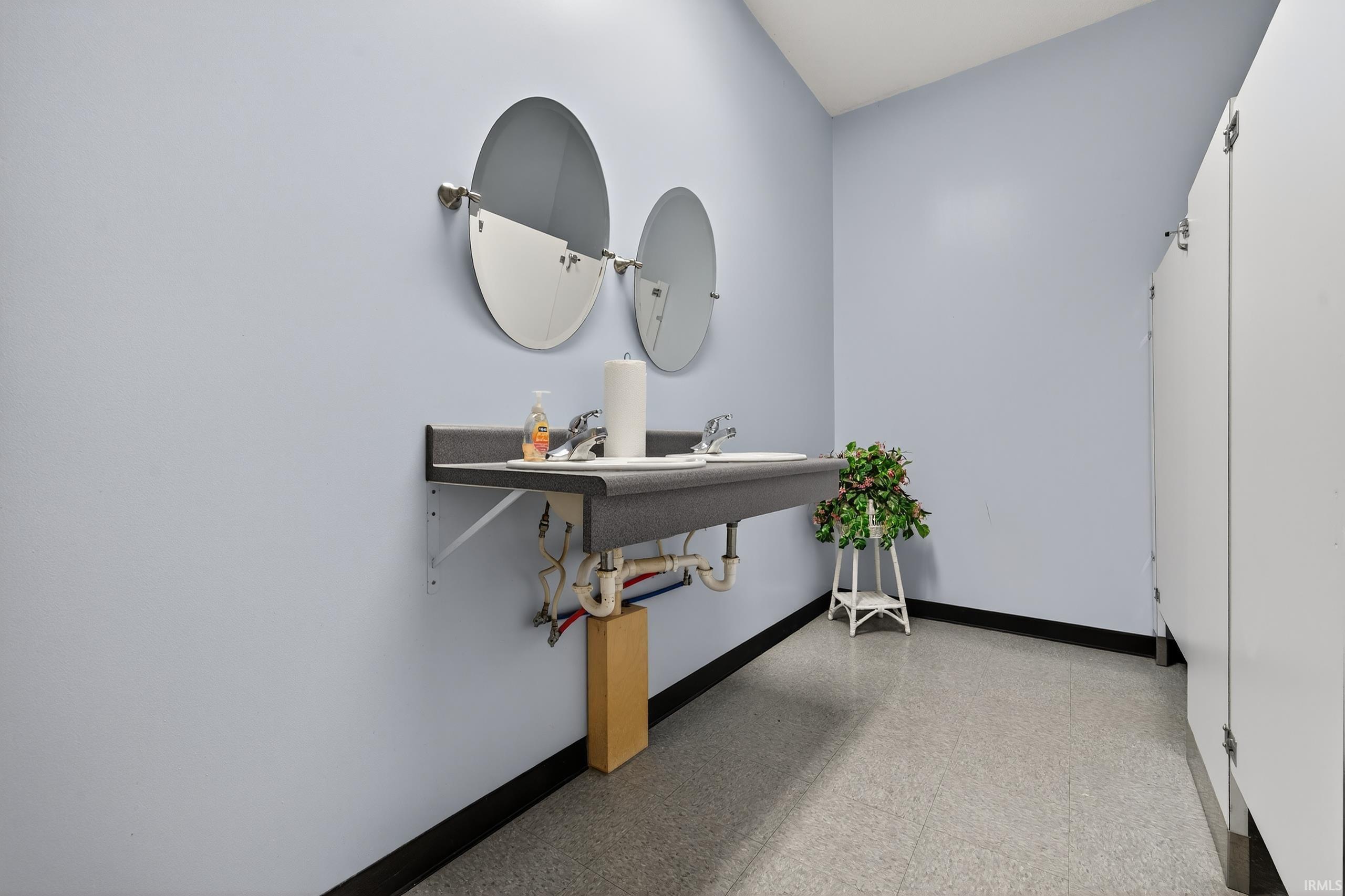 Bathroom with baseboards and light flooring