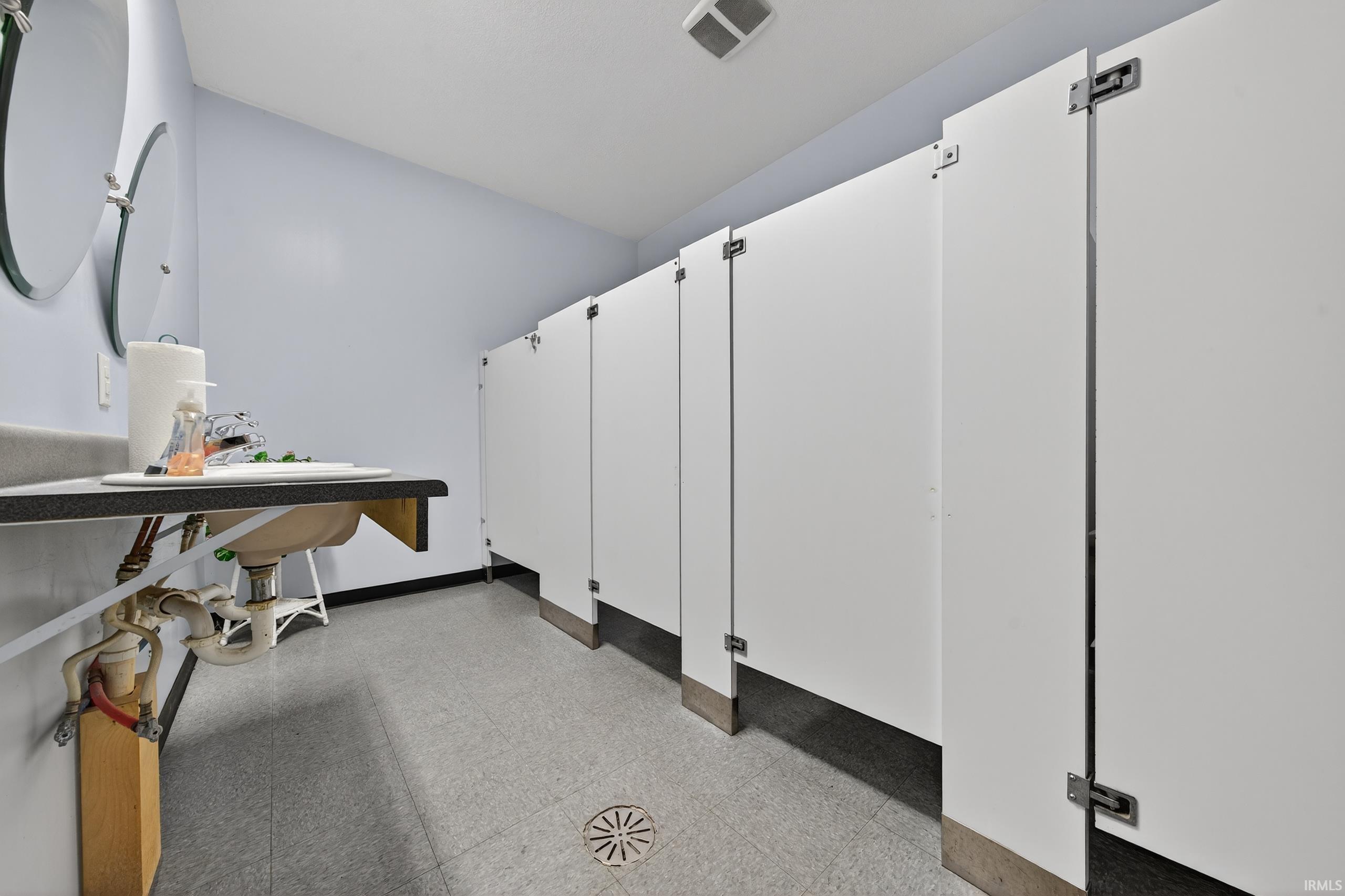 Miscellaneous room featuring light flooring and baseboards