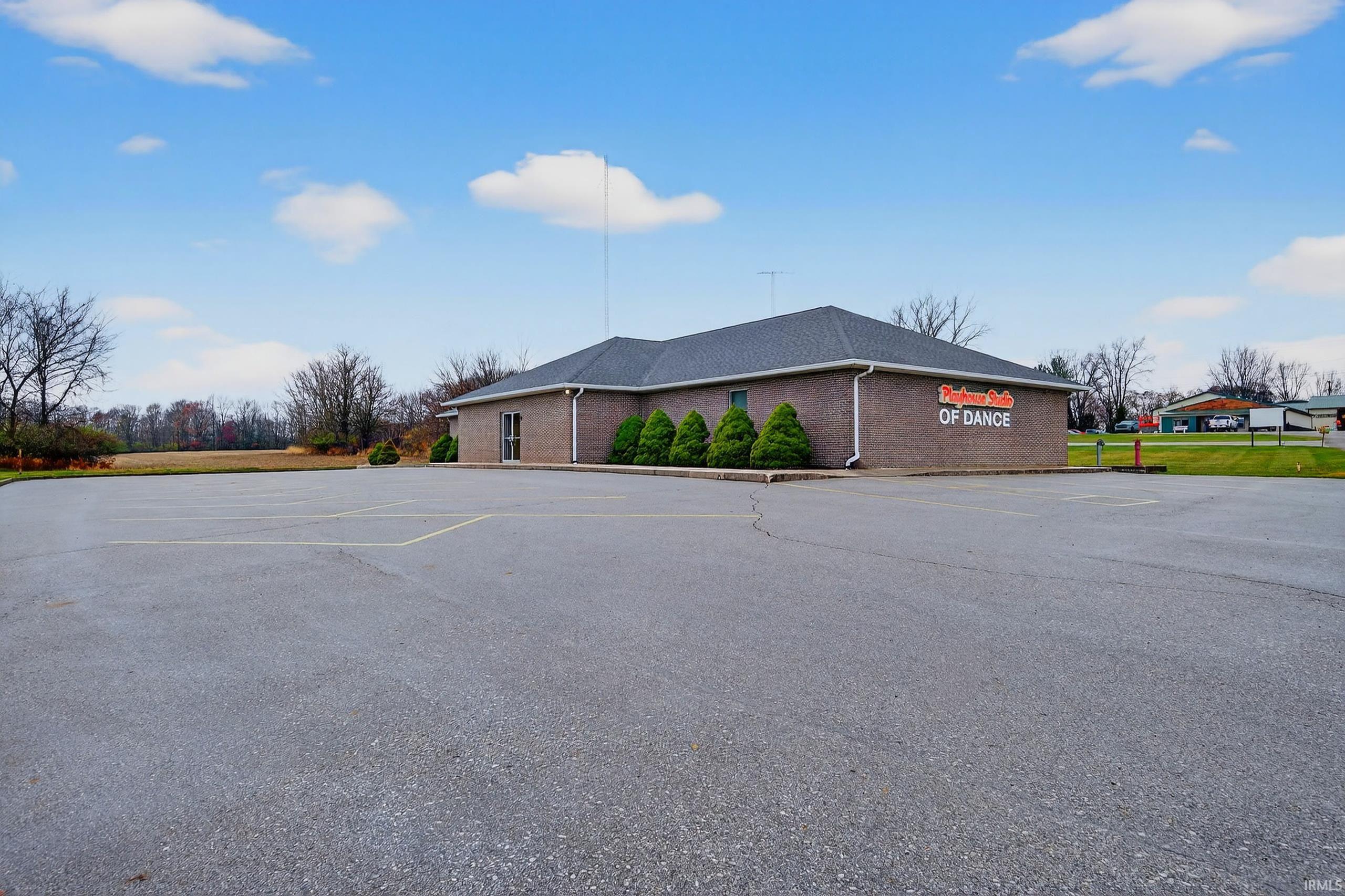 View of property with uncovered parking