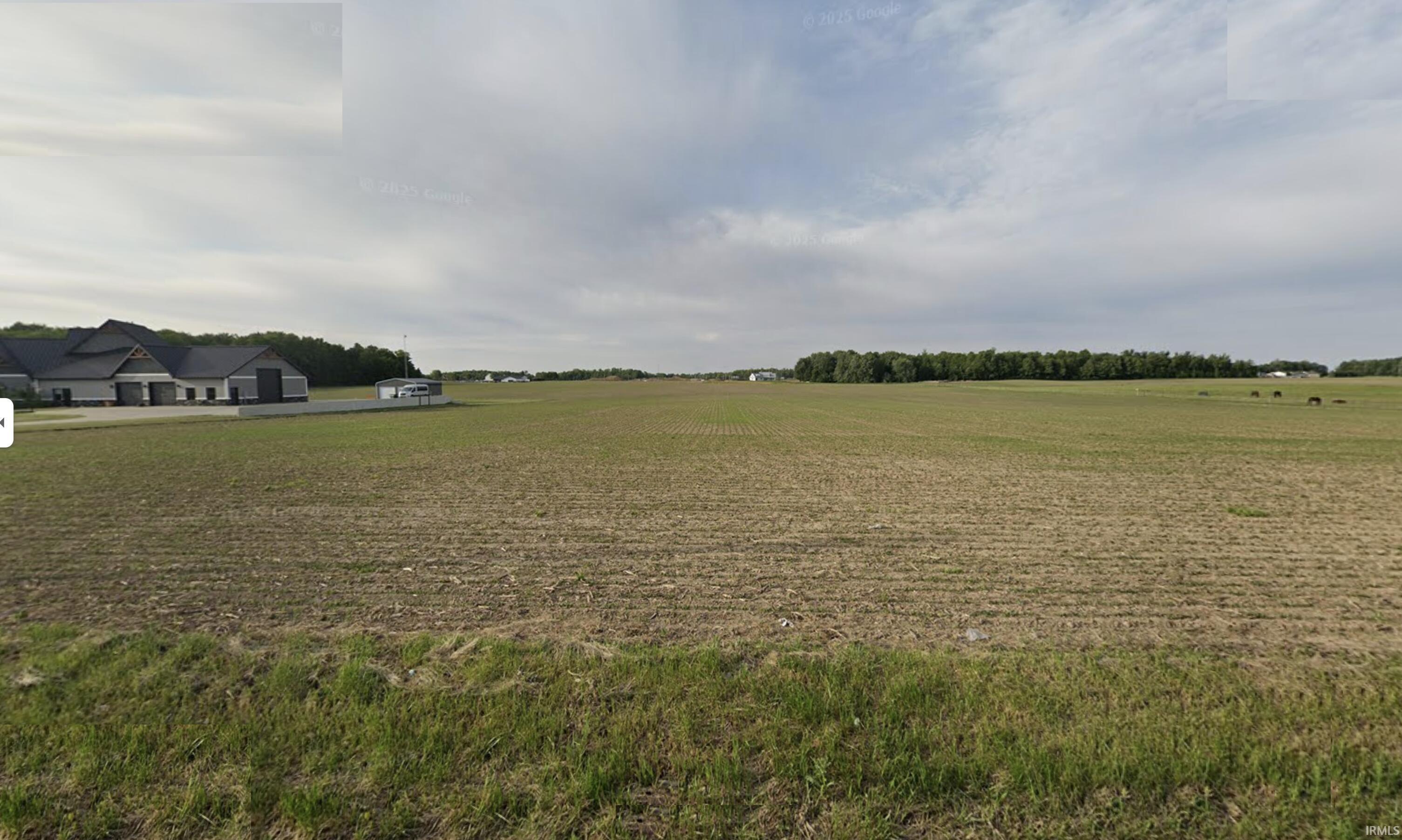 View of grassy yard featuring a rural view and agricultural area