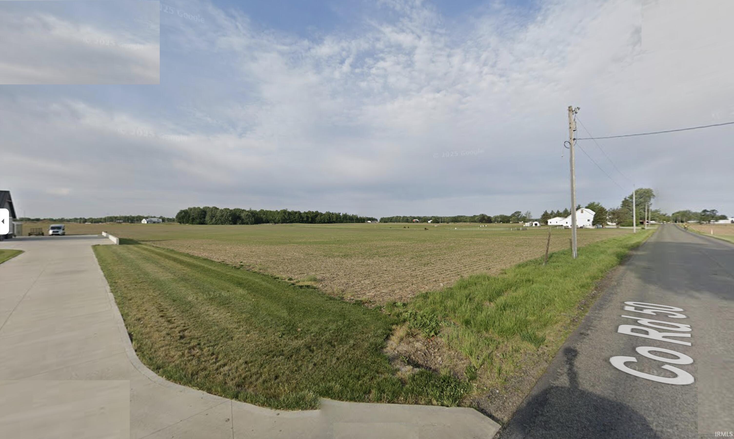 View of asphalt street with a view of rural / pastoral area