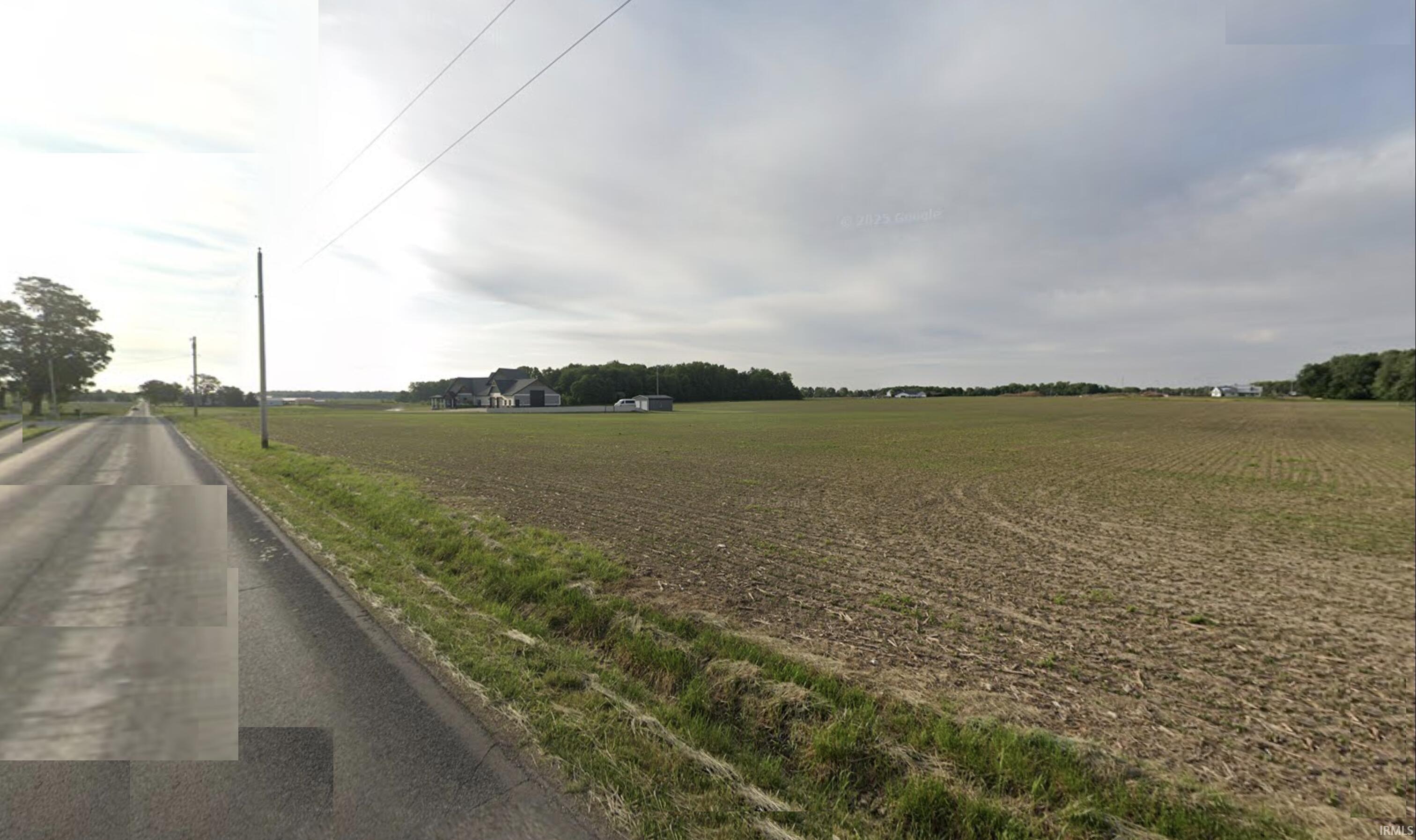 View of asphalt street with a view of countryside and agricultural area