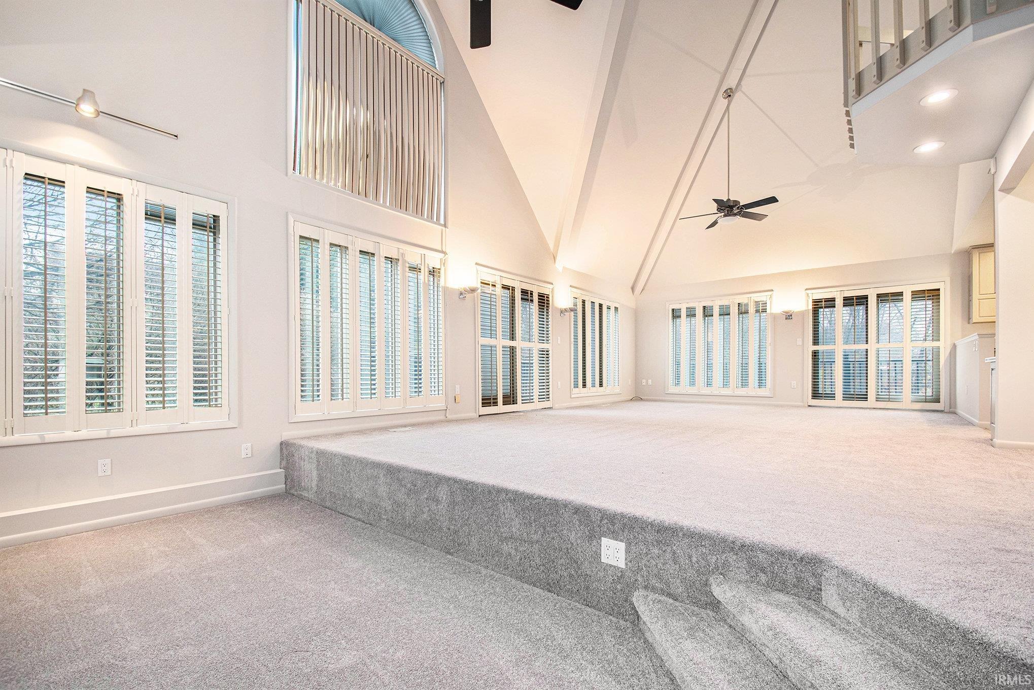 Sunken seating area around the fireplace, open to the living room and dining room