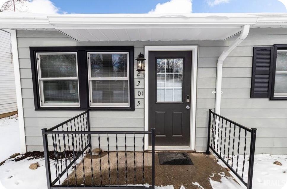 Property entrance featuring covered porch