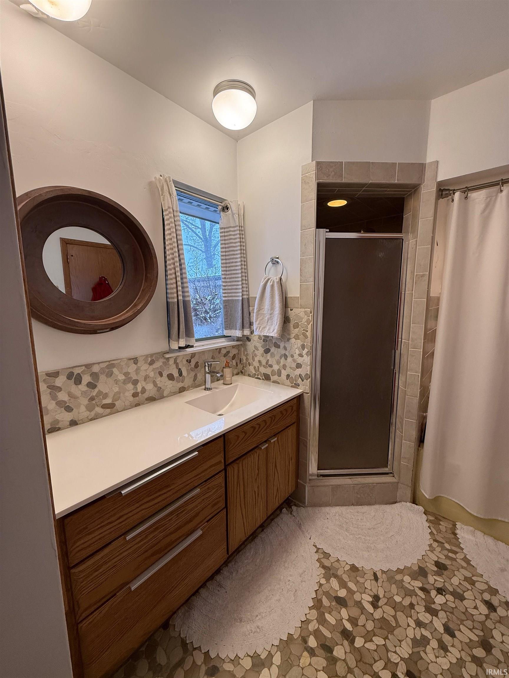 Full bathroom with a stall shower and vanity