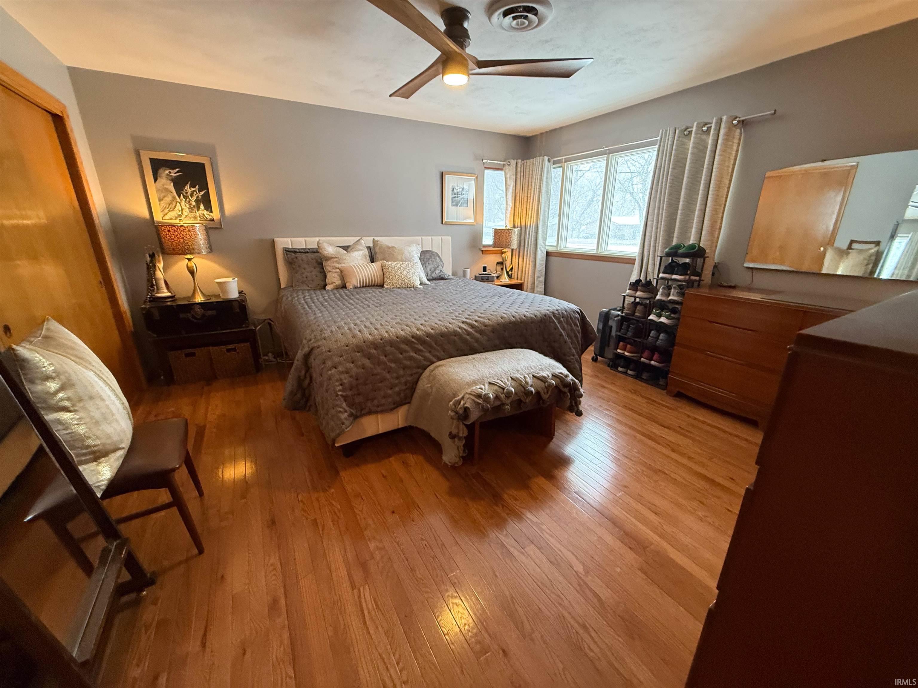 Bedroom featuring light wood-type flooring and a ceiling fan