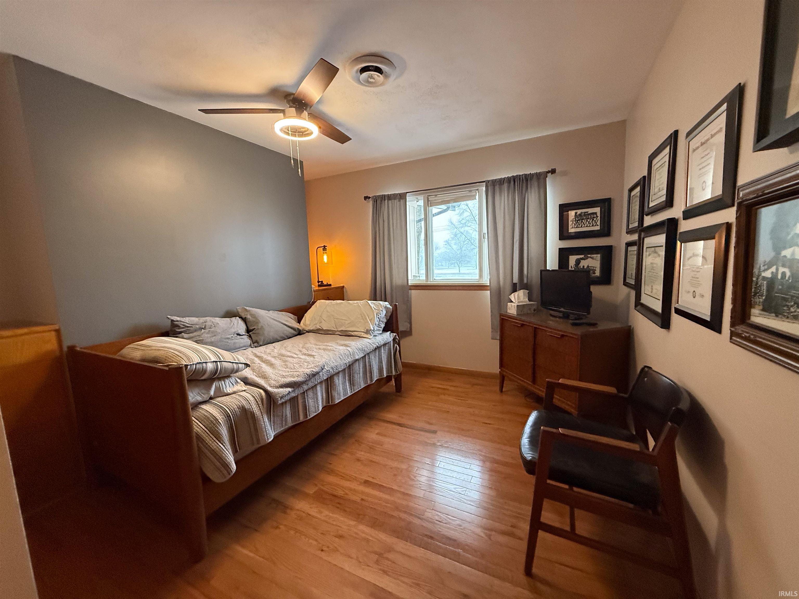 Bedroom featuring light wood finished floors and a ceiling fan