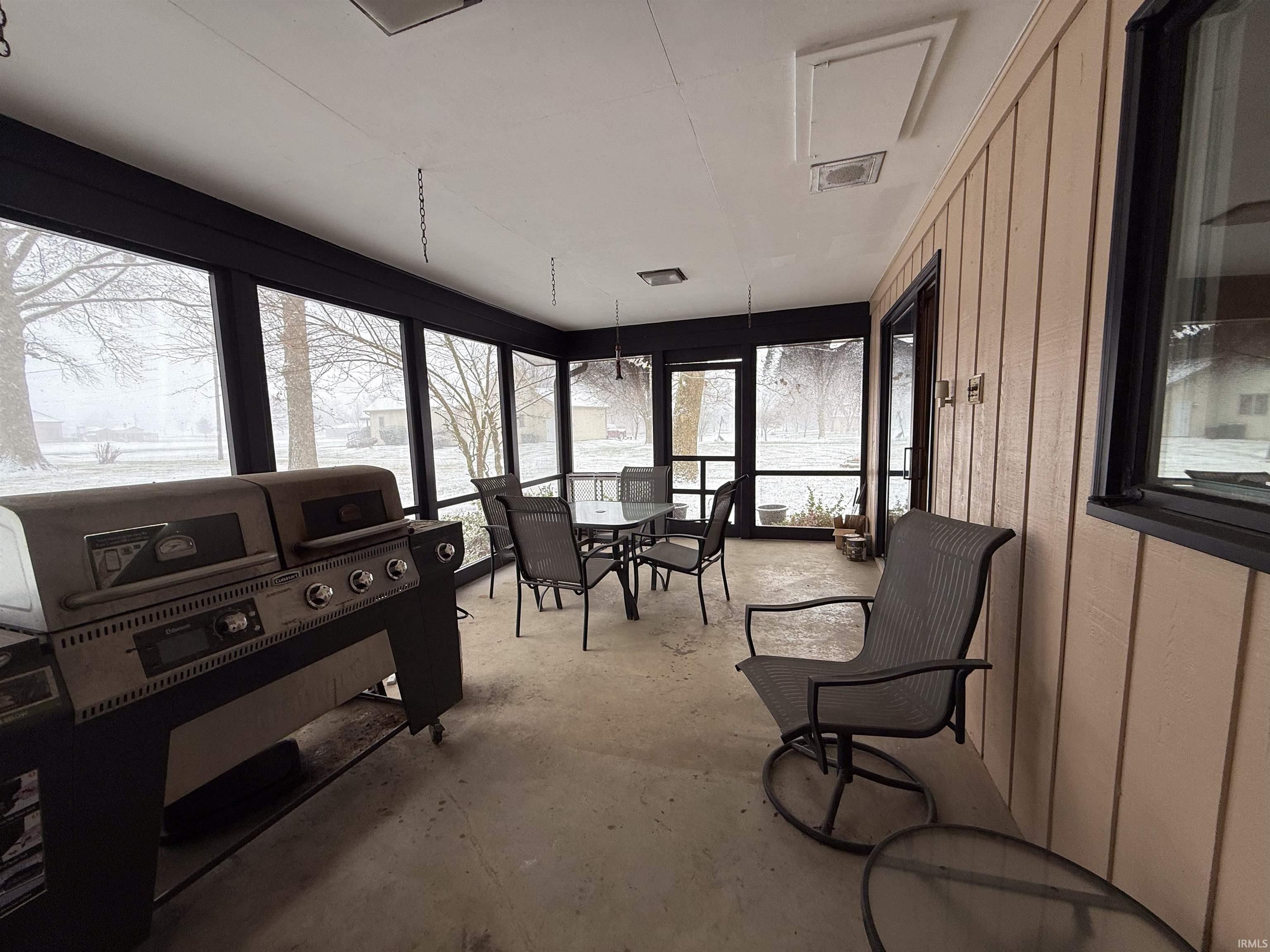 Sunroom with concrete flooring