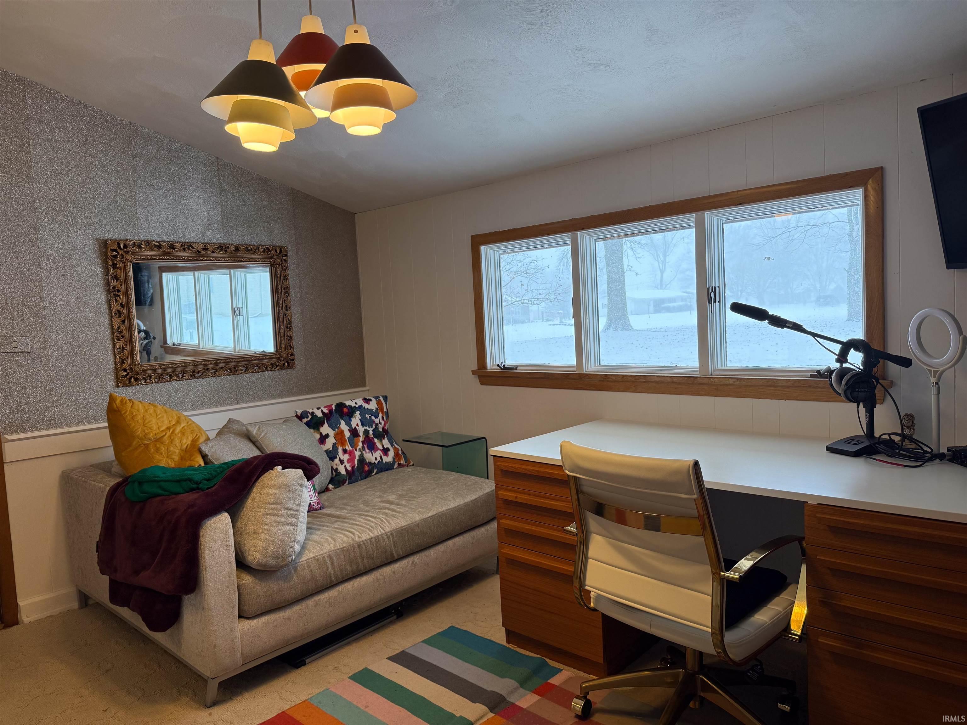 Office area featuring vaulted ceiling and a chandelier