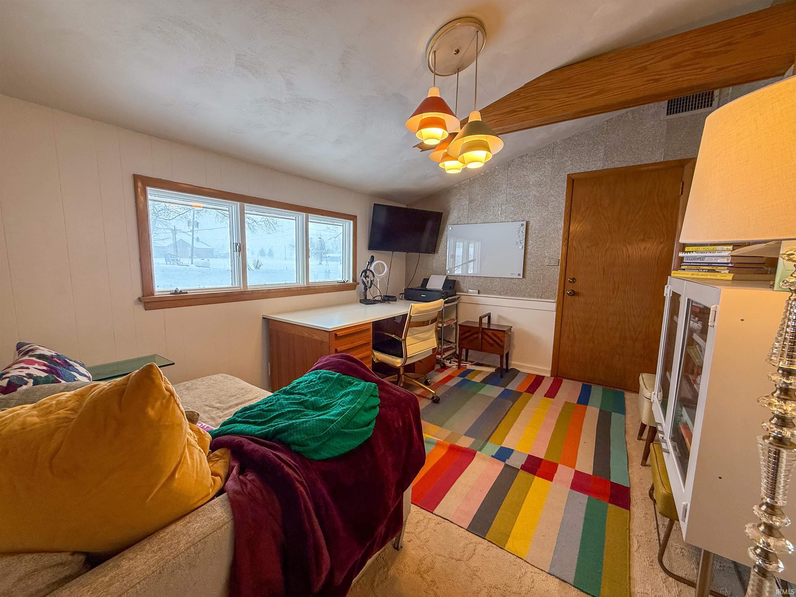 Office area featuring lofted ceiling