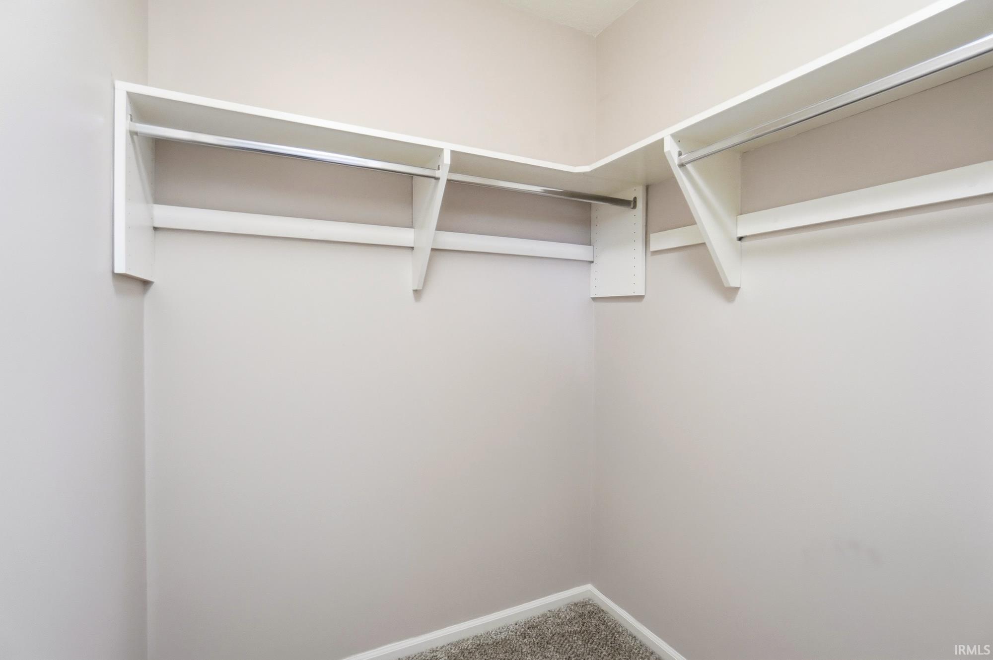 Spacious closet with carpet