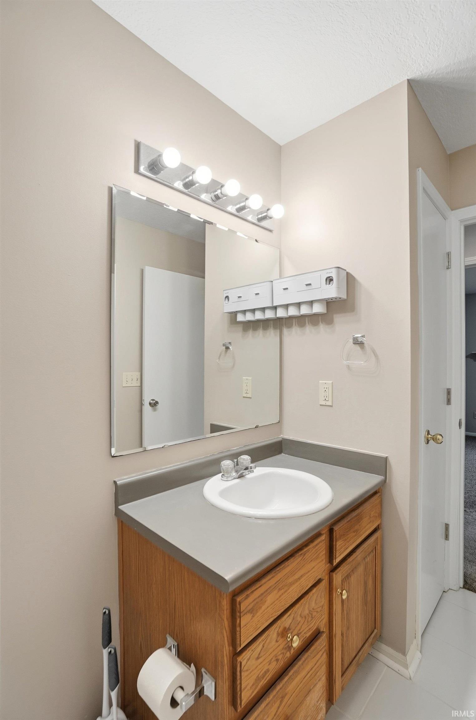 Bathroom featuring vanity and light tile patterned flooring