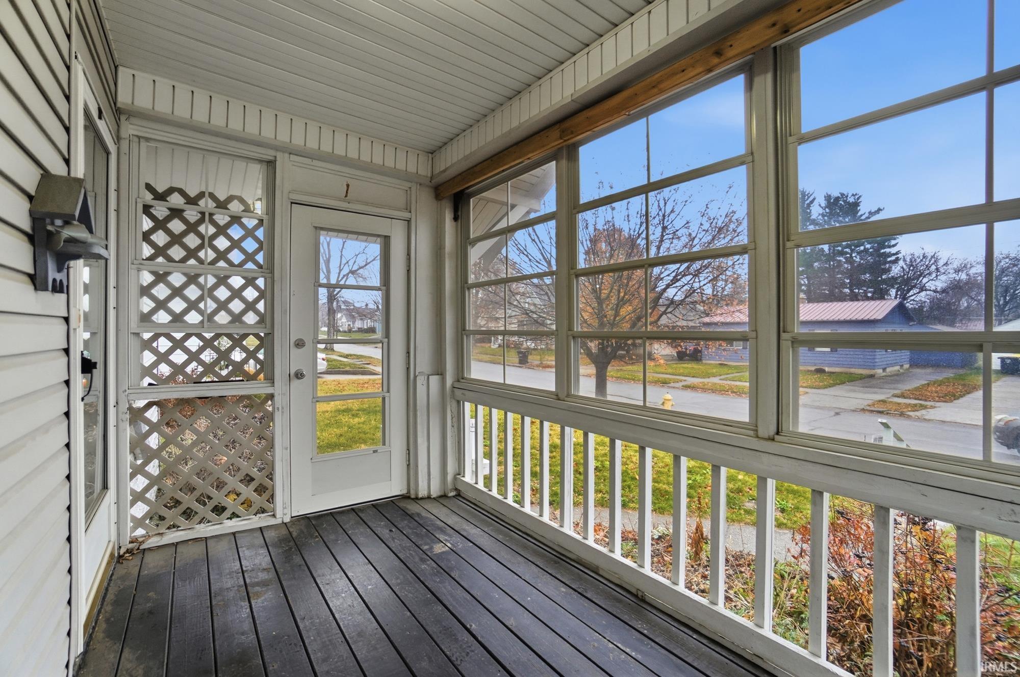 Unfurnished sunroom featuring a water view