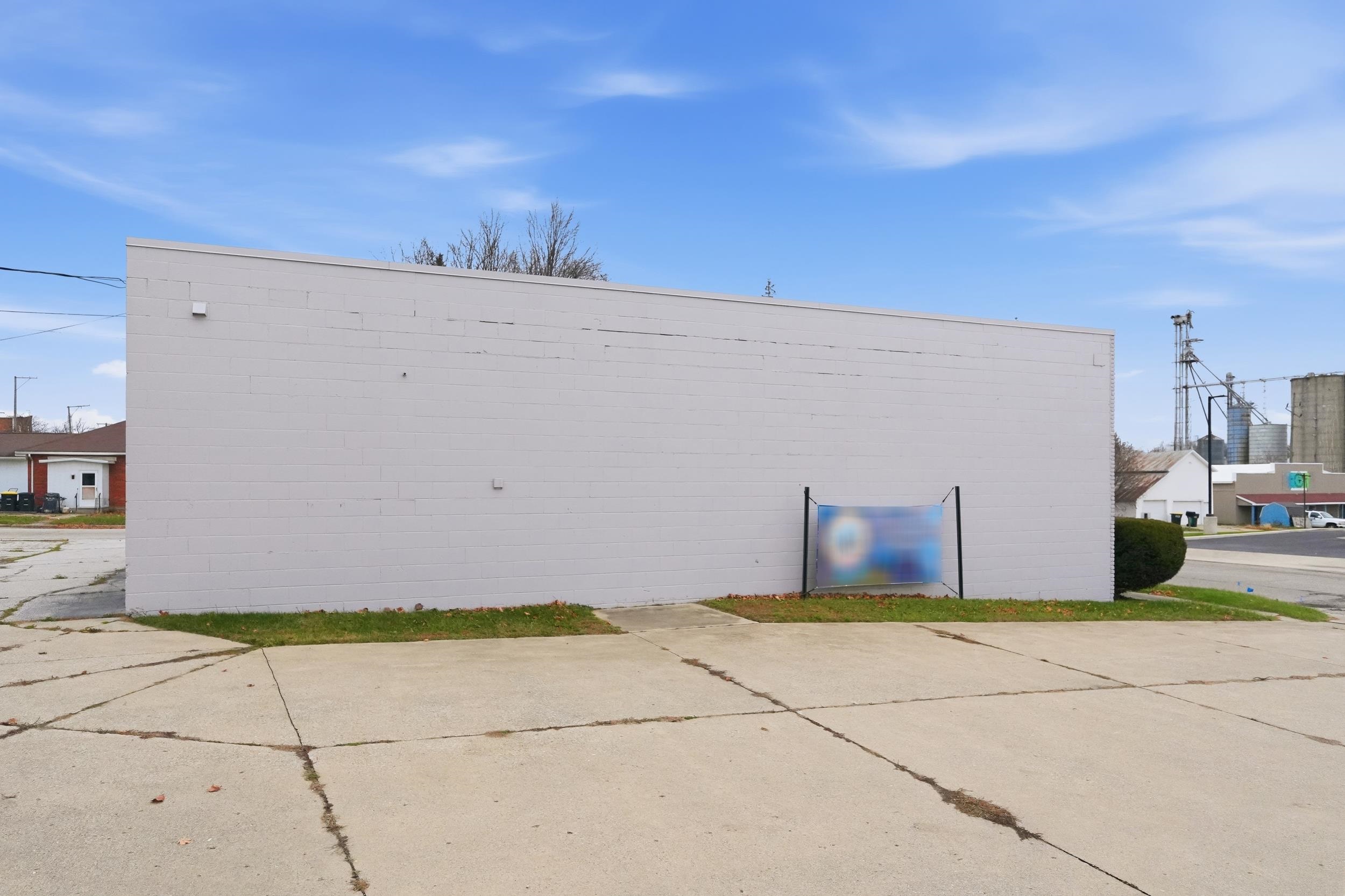 View of property exterior featuring concrete block siding
