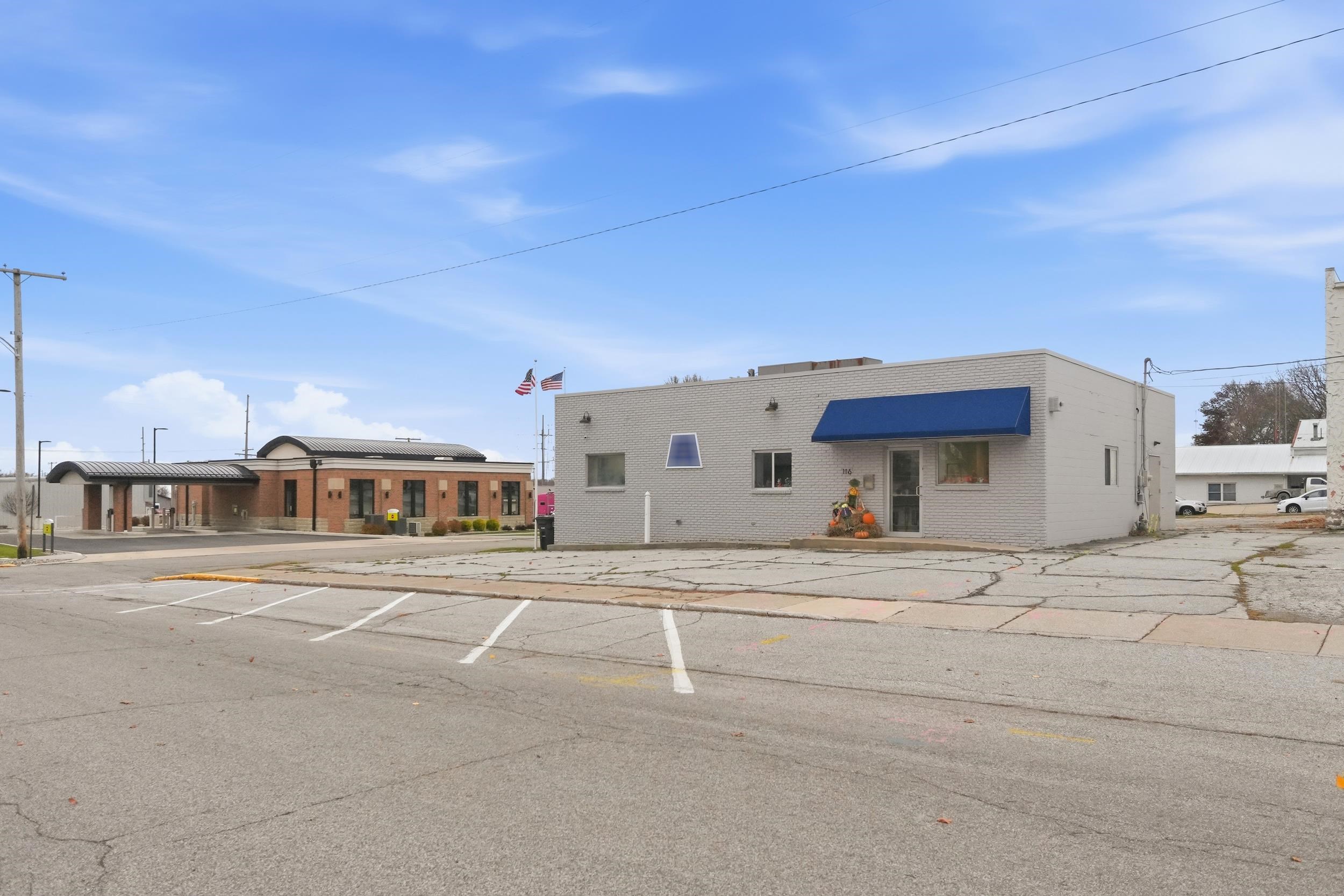 View of front of property with brick siding and uncovered parking